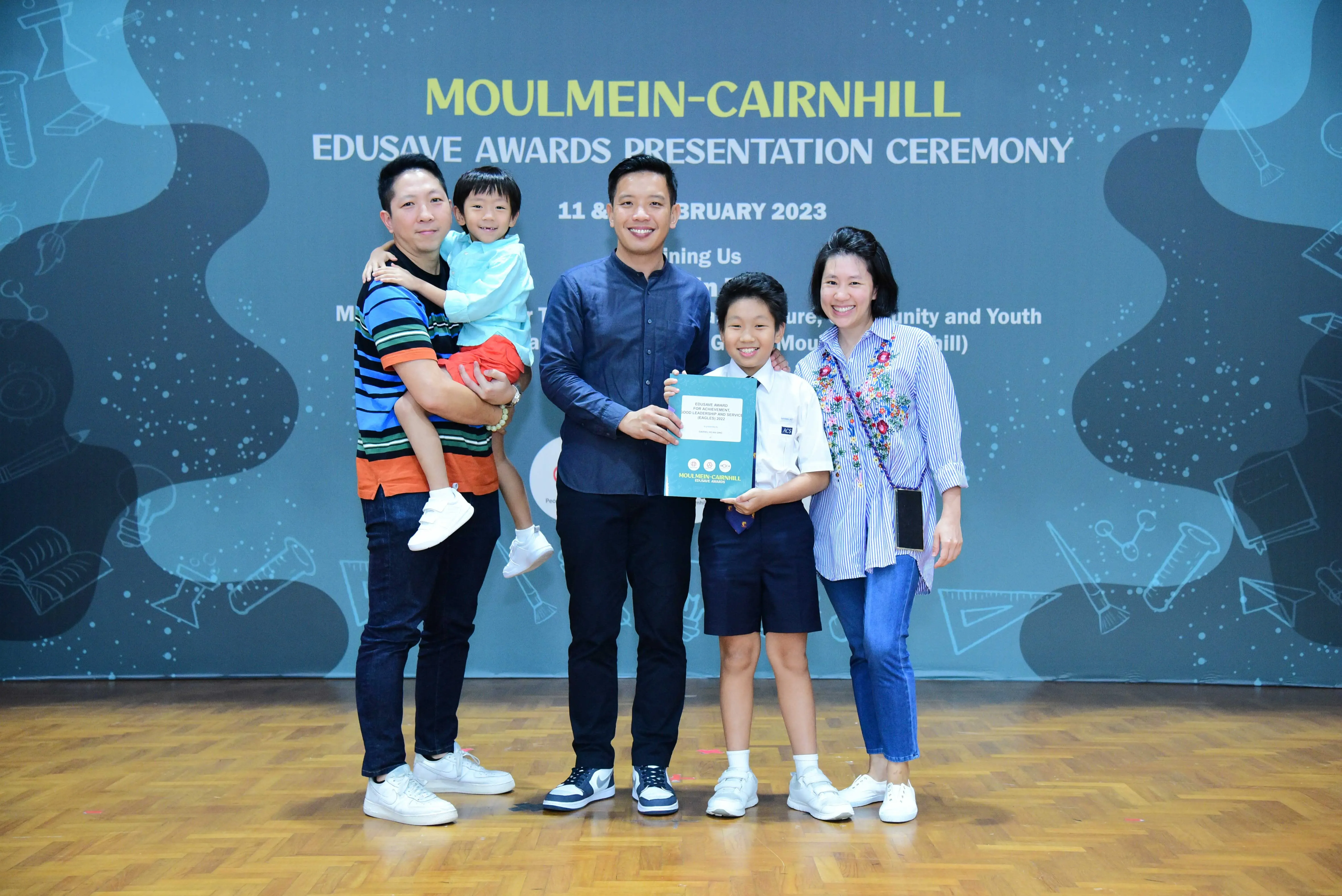 Five people pose at the Moulmein-Cairnhill Edusave Awards Presentation Ceremony in February 2023.