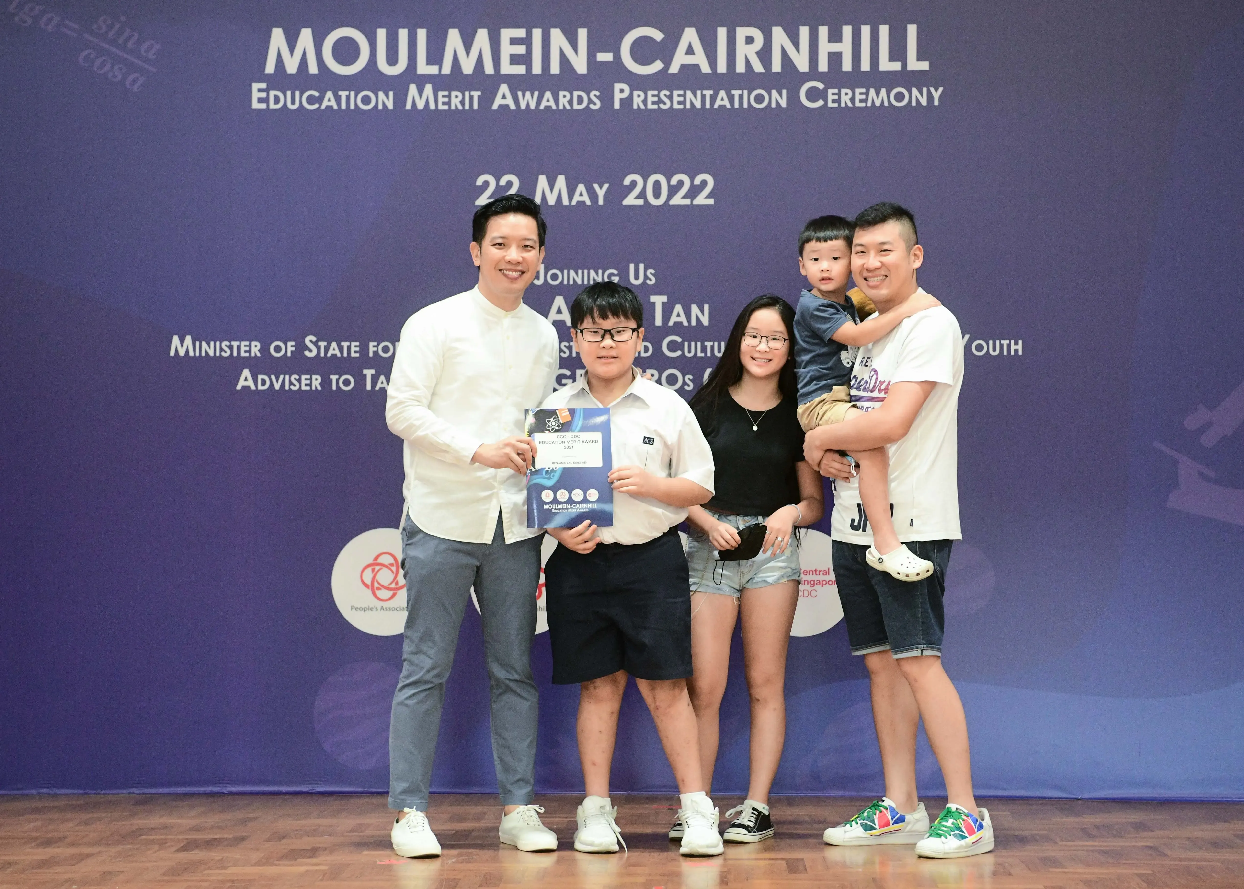 Family of five poses at the Moulmein-Cairnhill Education Merit Awards Presentation Ceremony on 22 May 2022.