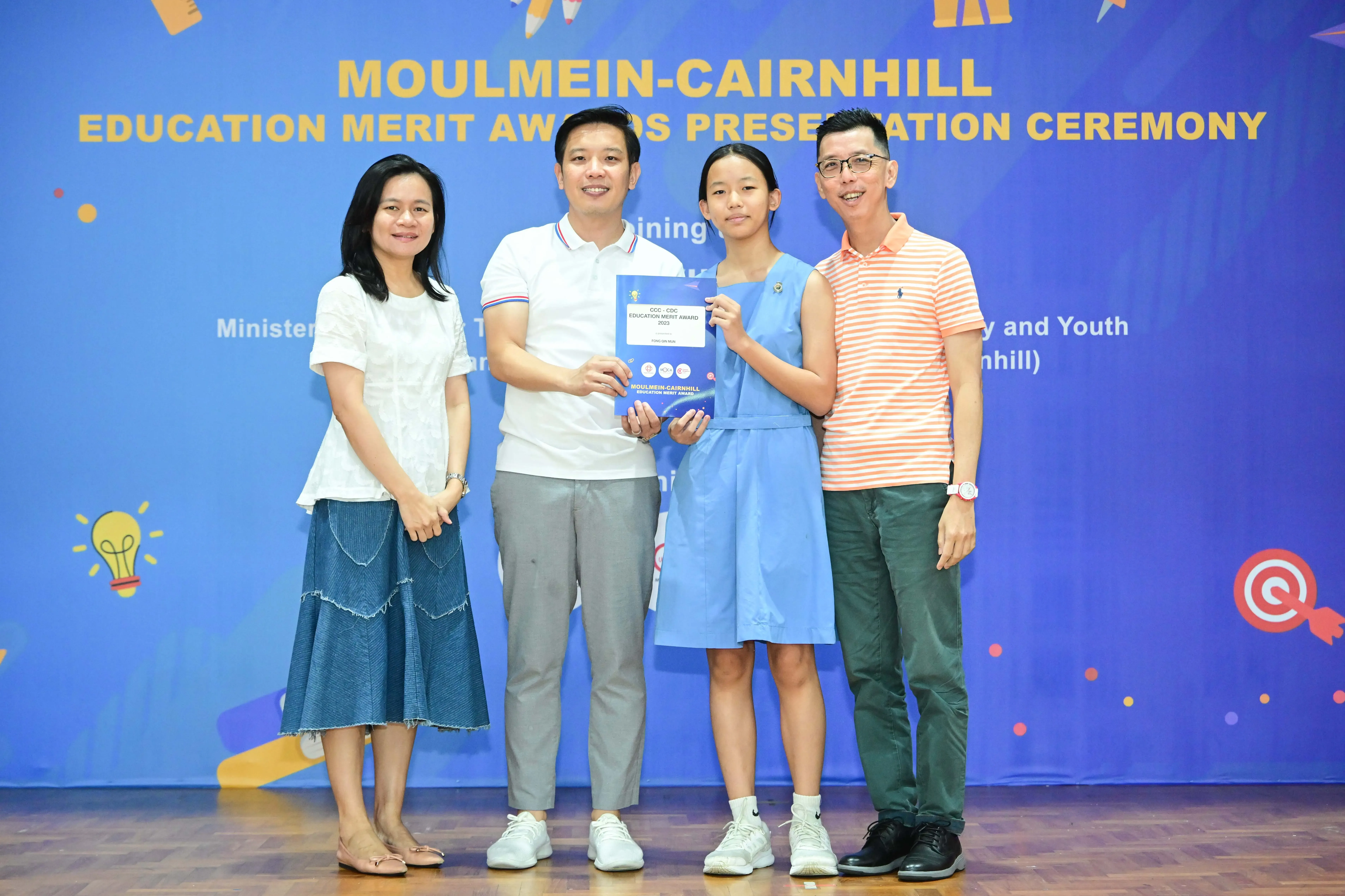 Four people pose with a certificate at the Moulmein-Cairnhill Education Merit Awards Presentation Ceremony.