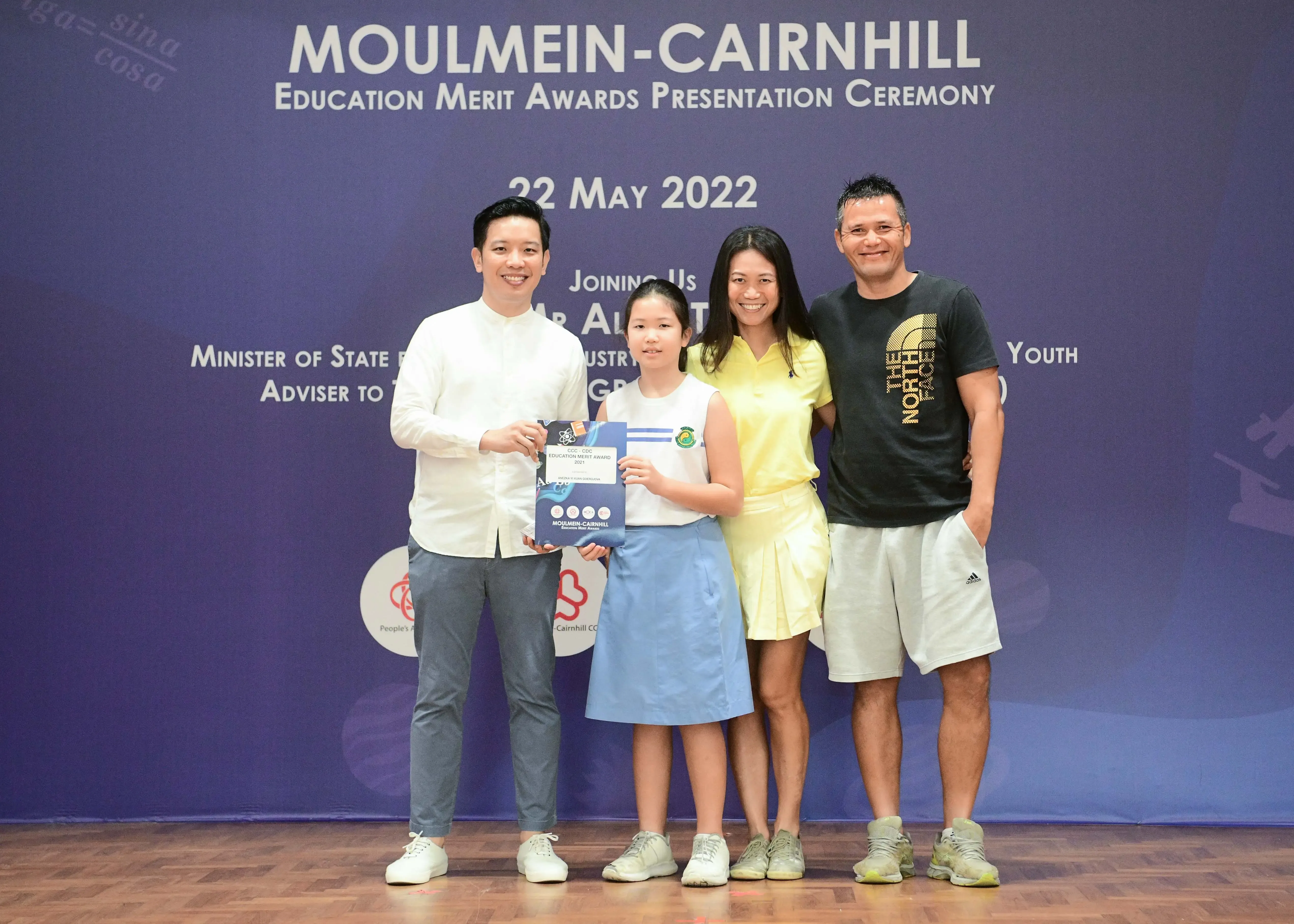 Four people pose with an award certificate at the Moulmein-Cairnhill Education Merit Awards Presentation Ceremony on 22 May 2022.