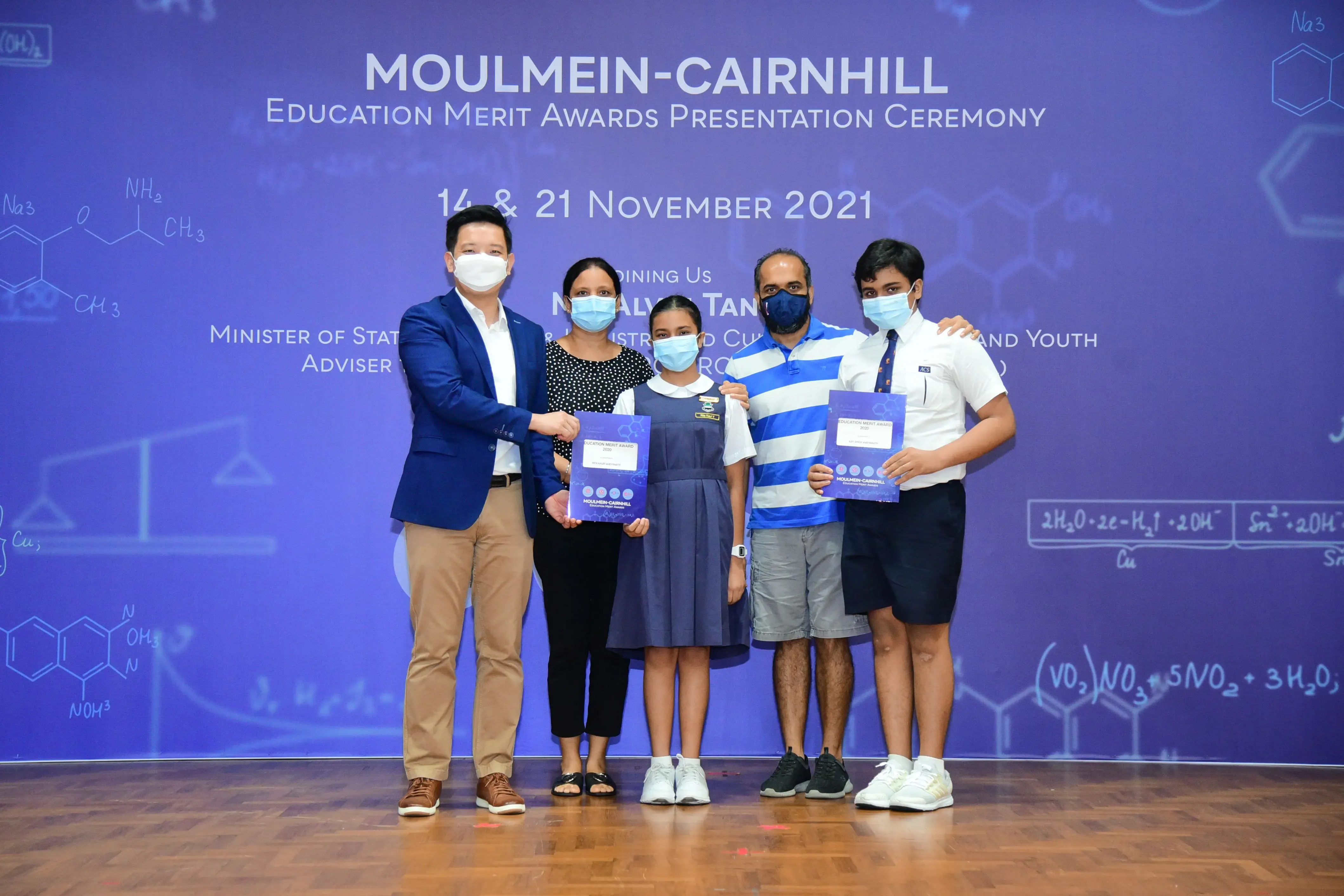 Five masked people pose at the Moulmein-Cairnhill Education Merit Awards Ceremony on November 2021.