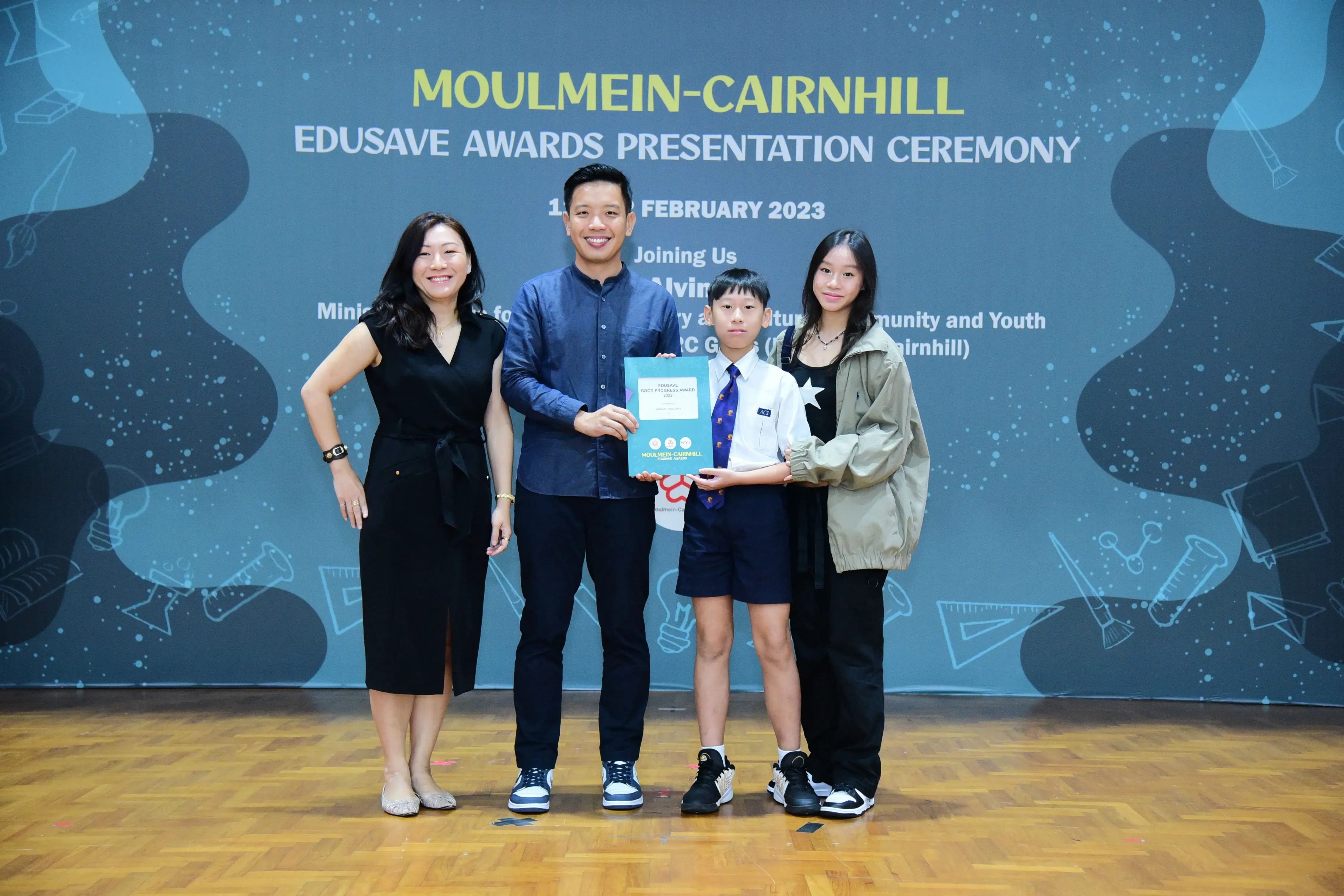 Four people pose at the Moulmein-Cairnhill Edusave Awards Presentation Ceremony in February 2023.