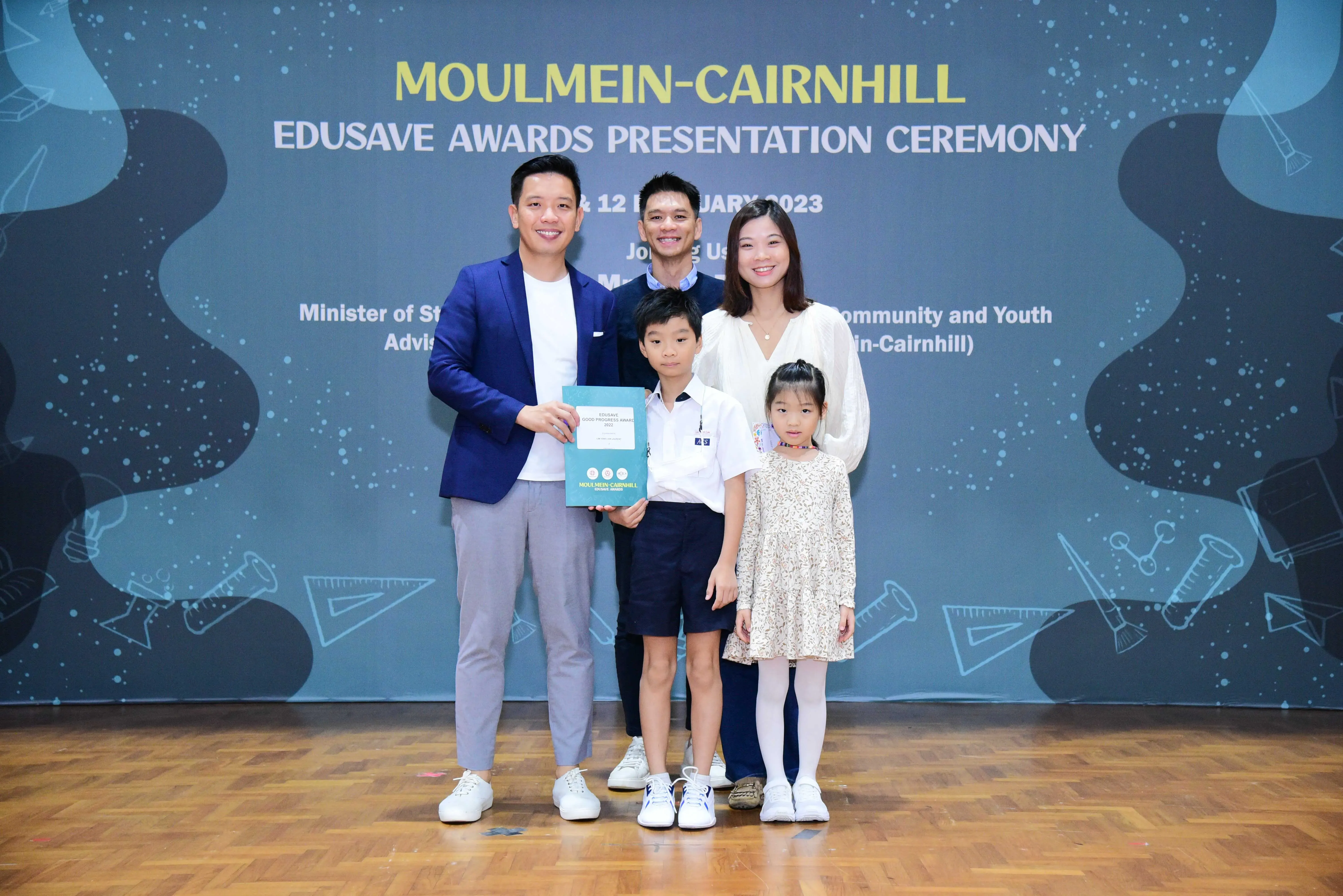 Five people pose with an award at the Moulmein-Cairnhill Edusave Awards Presentation Ceremony 2023.