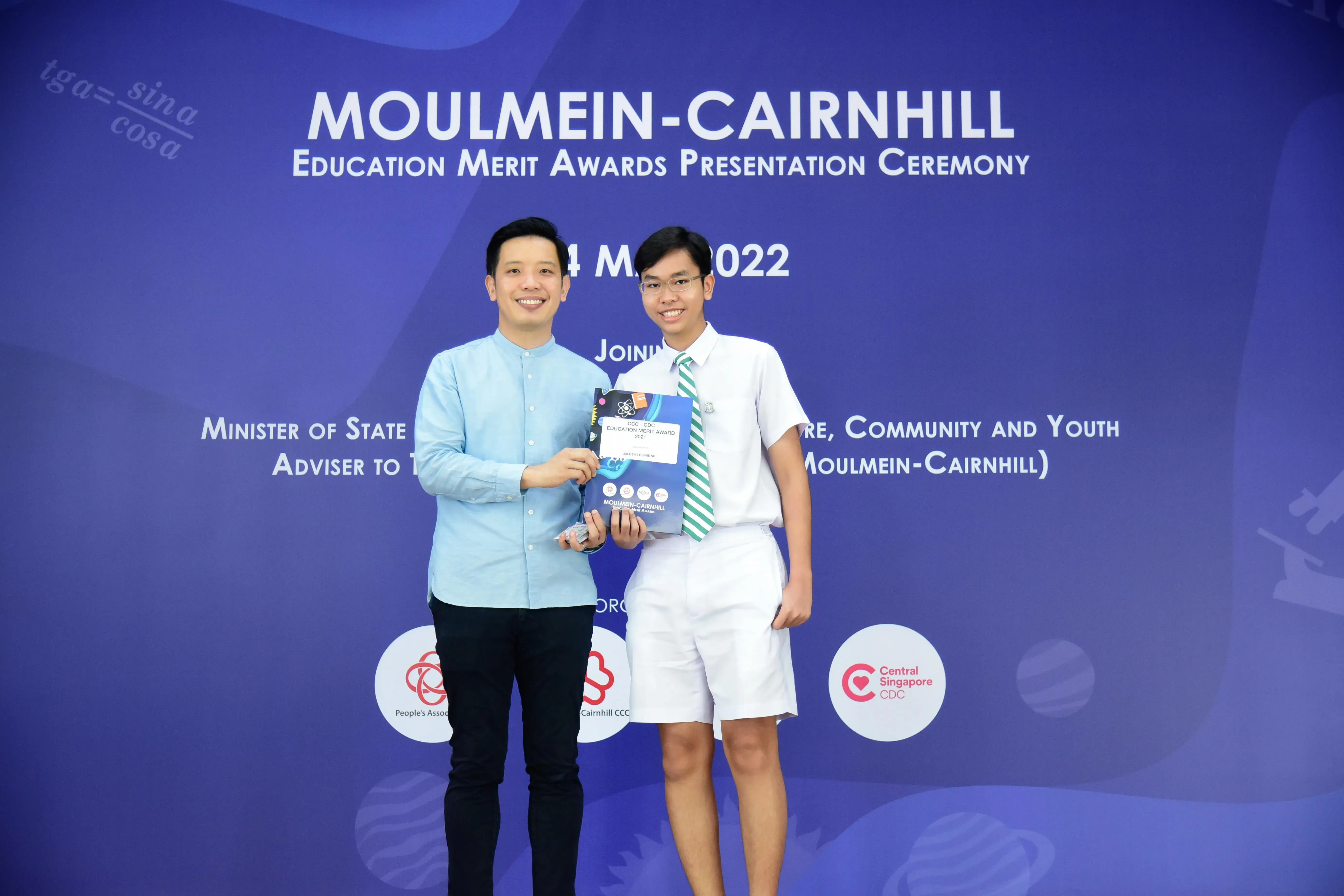 Two men pose holding an award at the Moulmein-Cairnhill Education Merit Awards Presentation Ceremony 2022.