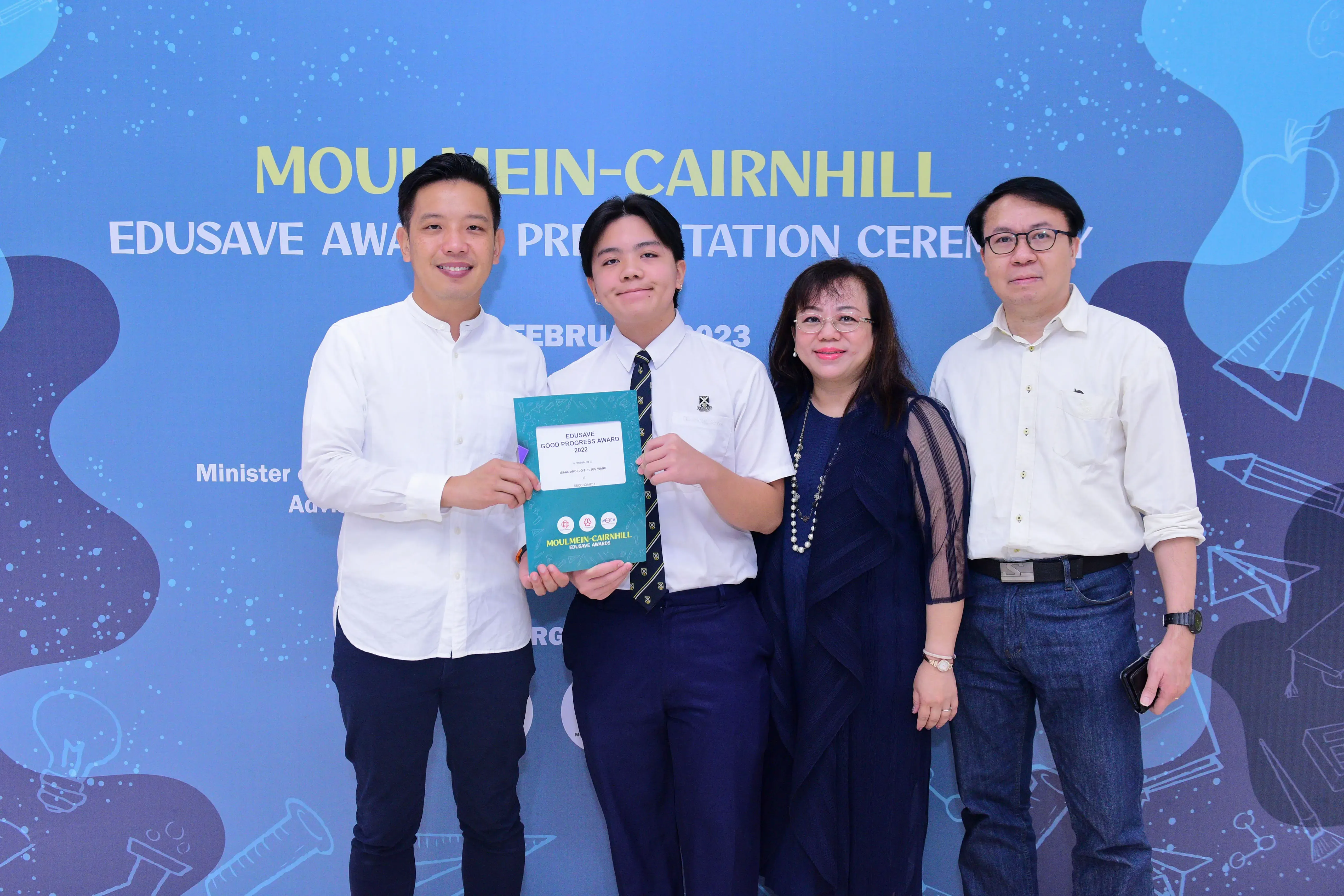 Four people pose at the Moulmein-Cairnhill Edusave Award Presentation Ceremony 2023, holding a certificate.