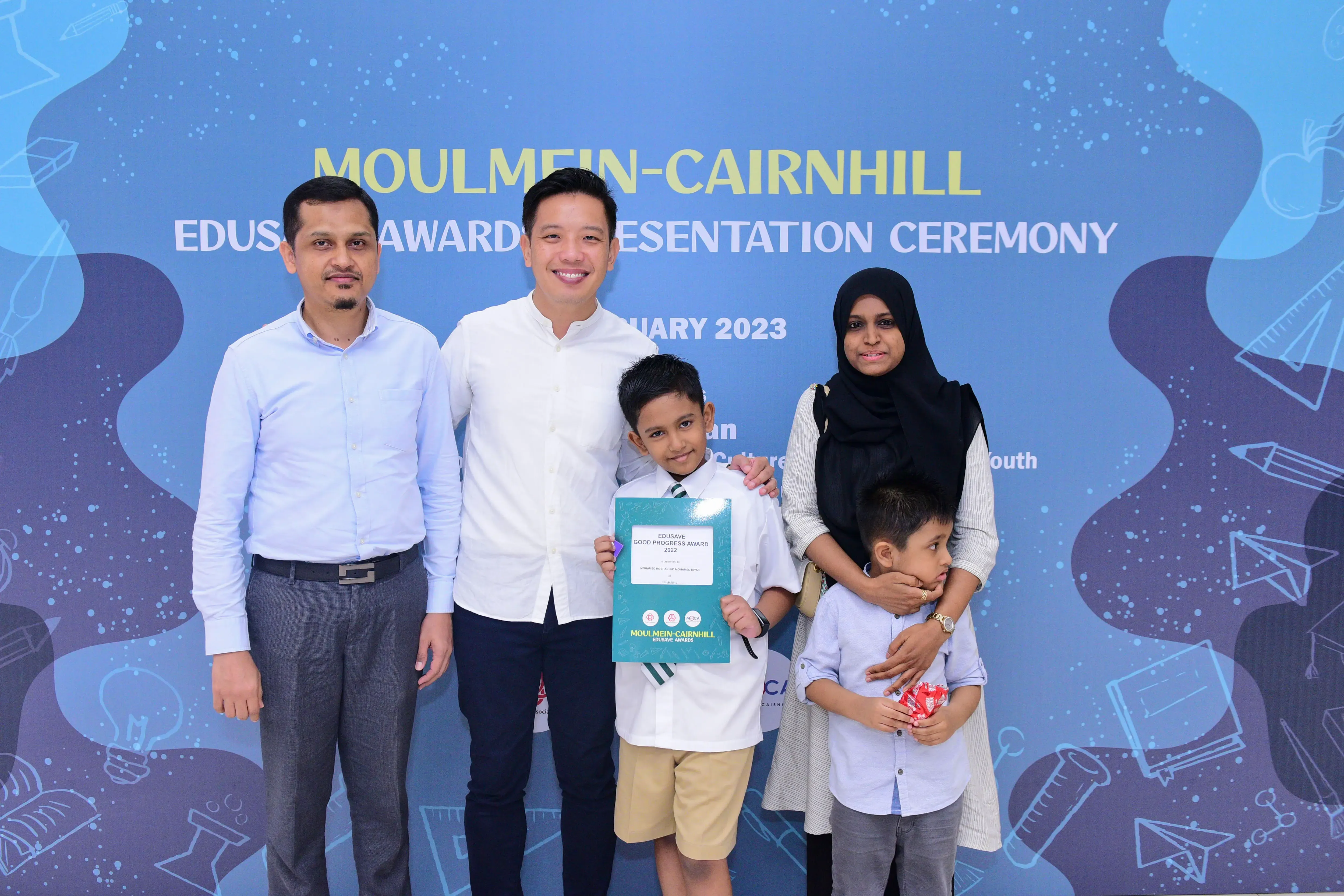 A boy holds an Edusave Good Progress Award certificate at the Moulmein-Cairnhill Awards Presentation Ceremony 2023.