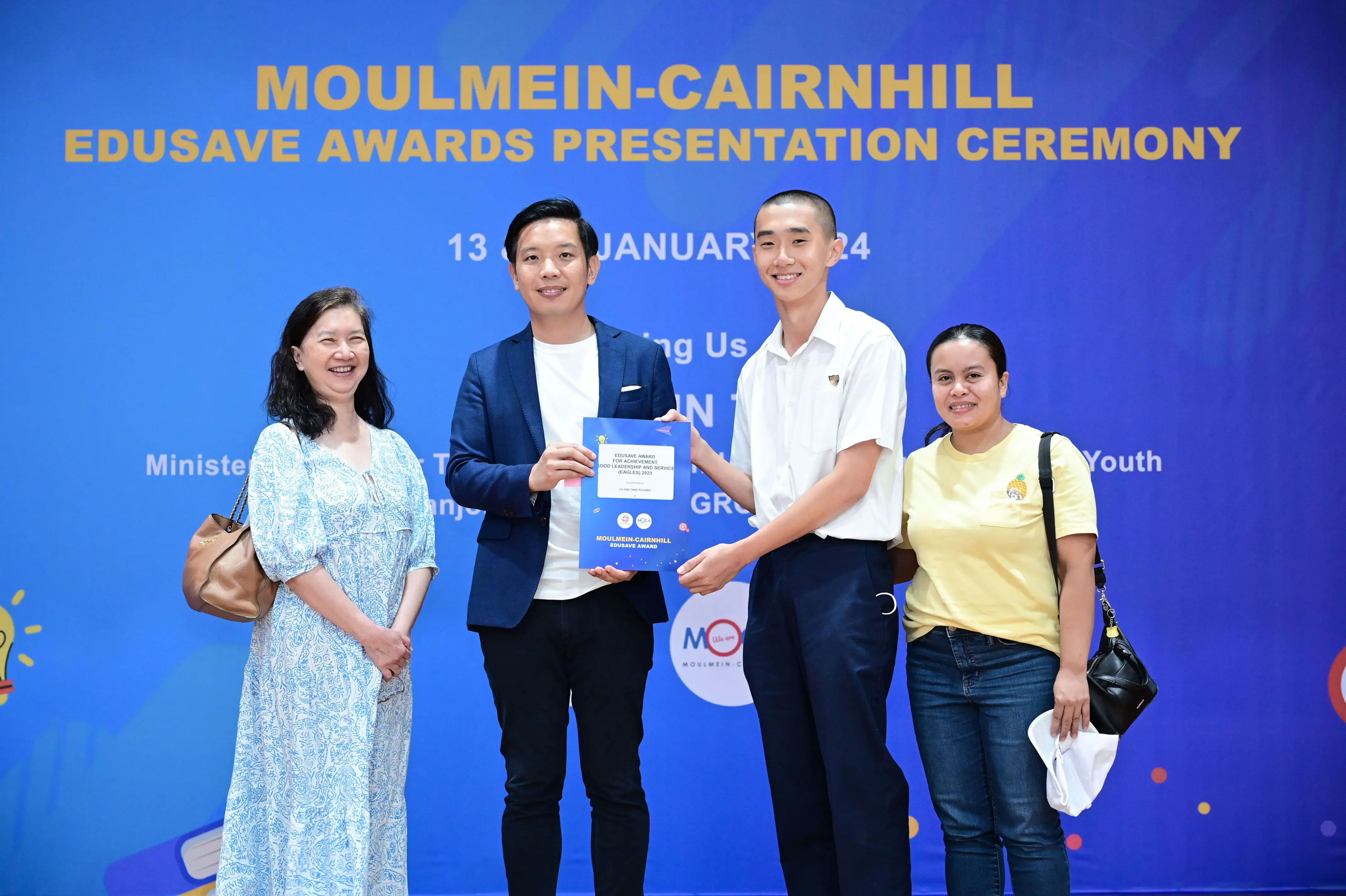 Four people pose at the Moulmein-Cairnhill Edusave Awards Presentation Ceremony on 13 January 2024.