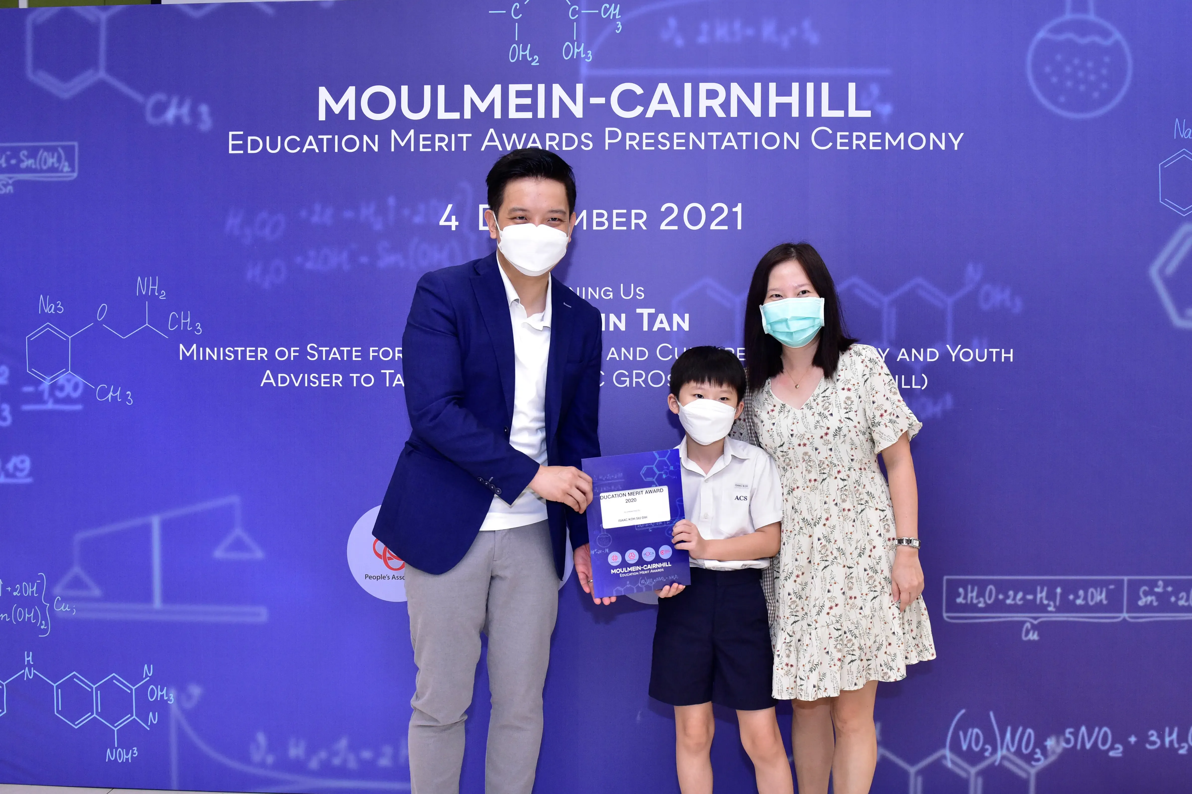 Three masked people pose at the Moulmein-Cairnhill Education Merit Awards ceremony on 4 December 2021.