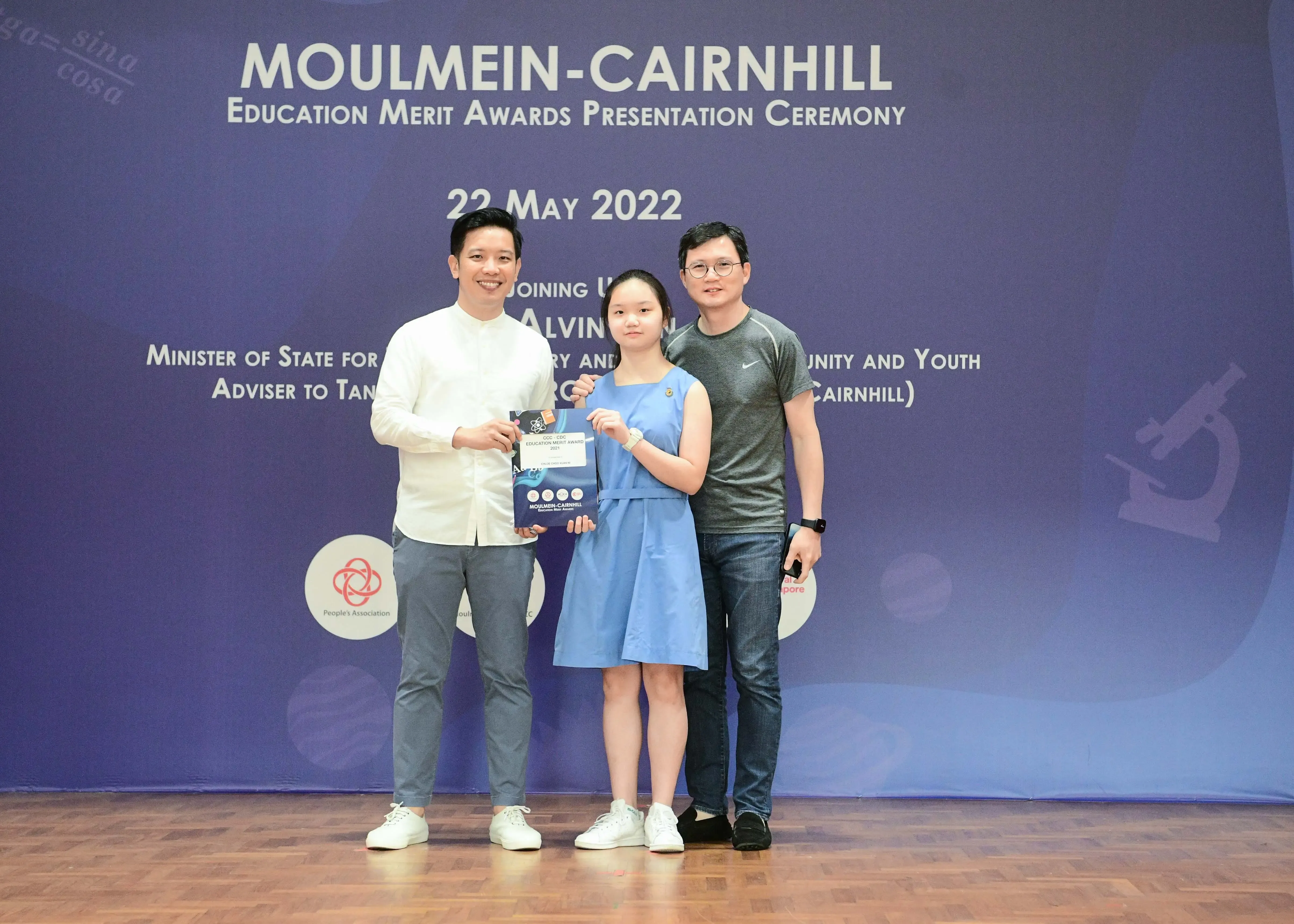 Three people pose at the Moulmein-Cairnhill Education Merit Awards Presentation Ceremony on 22 May 2022.