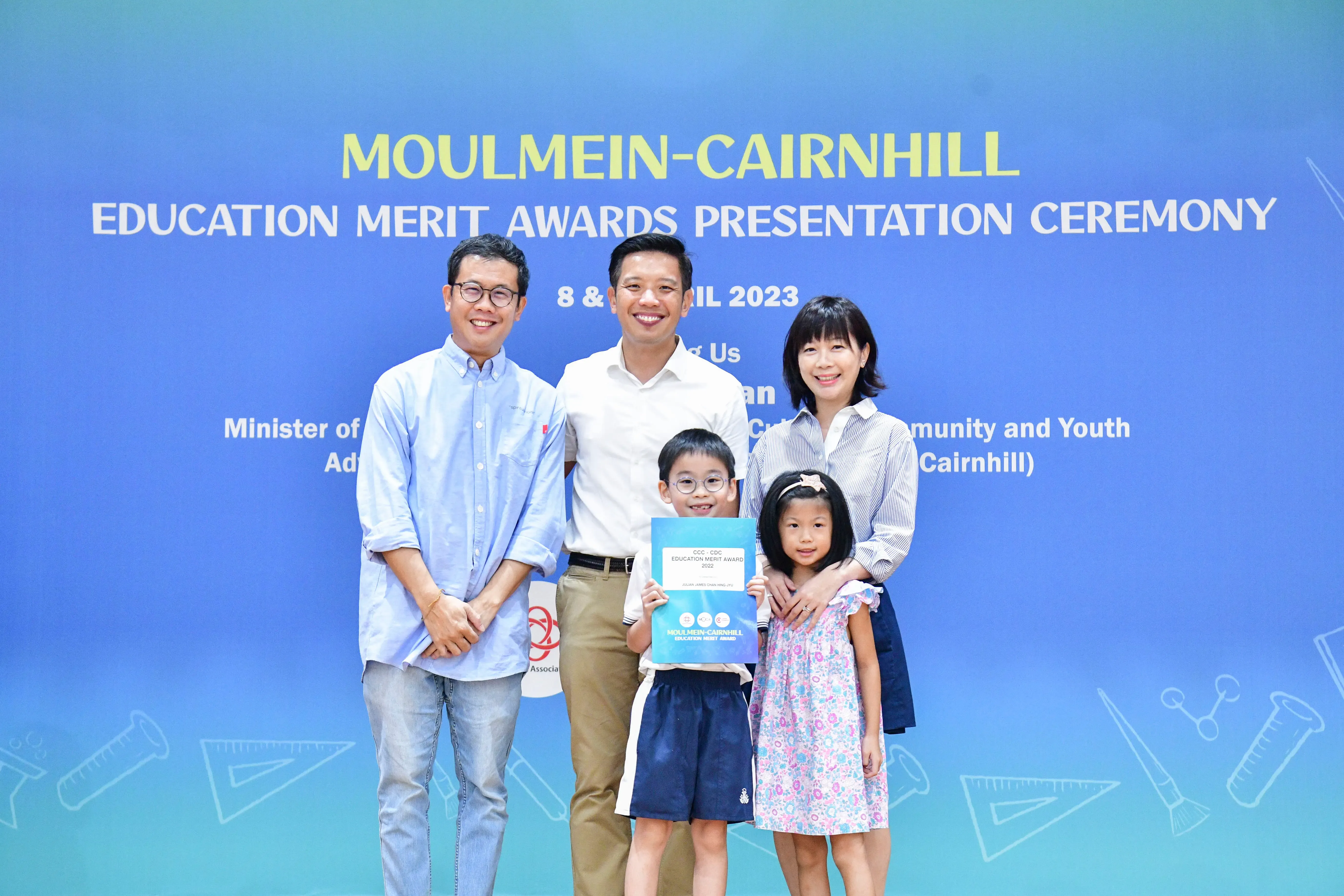 Three adults and two children pose at the Moulmein-Cairnhill Education Merit Awards Presentation Ceremony 2023.