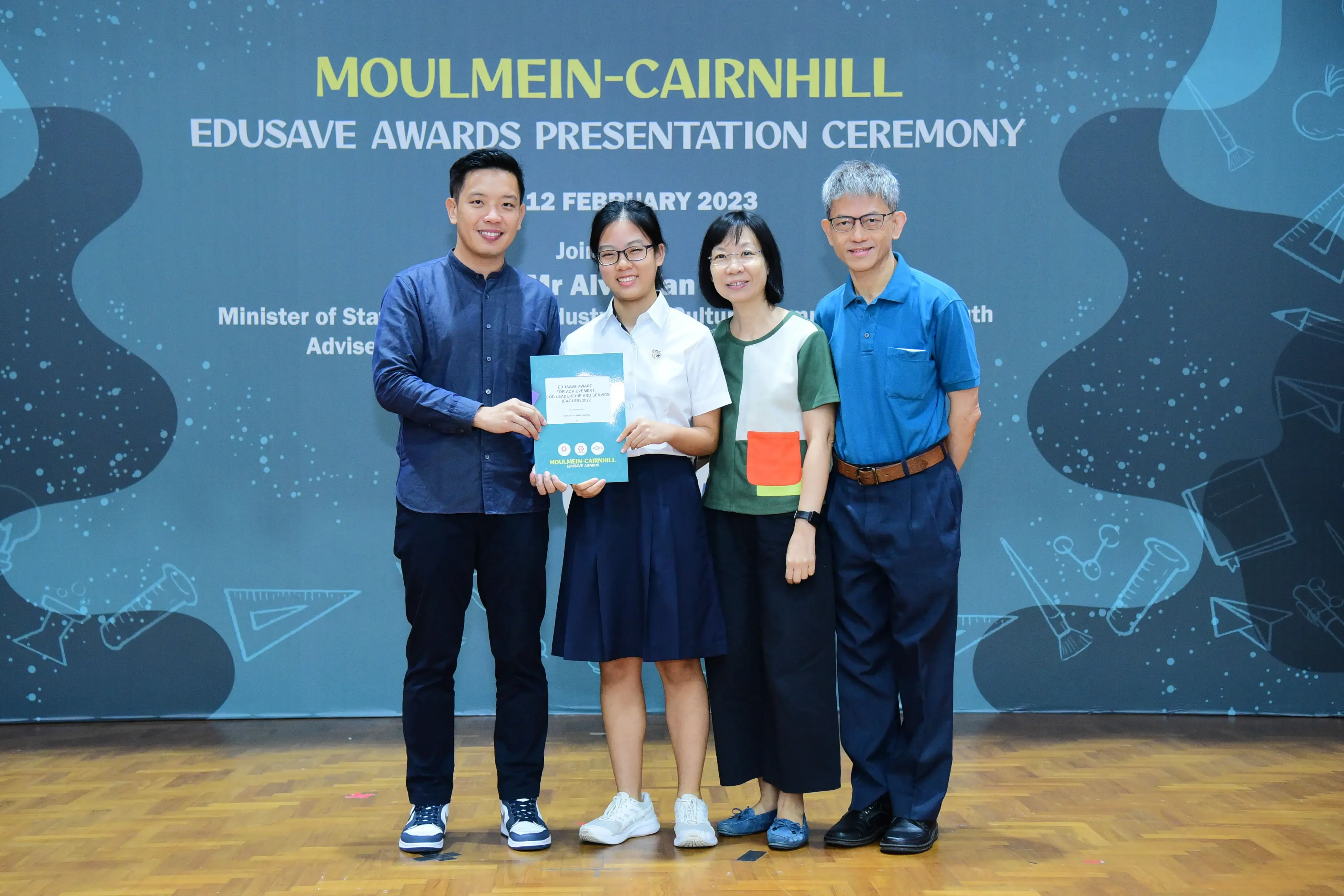 Four people pose at the Moulmein-Cairnhill Edusave Awards Presentation Ceremony on 12 February 2023.