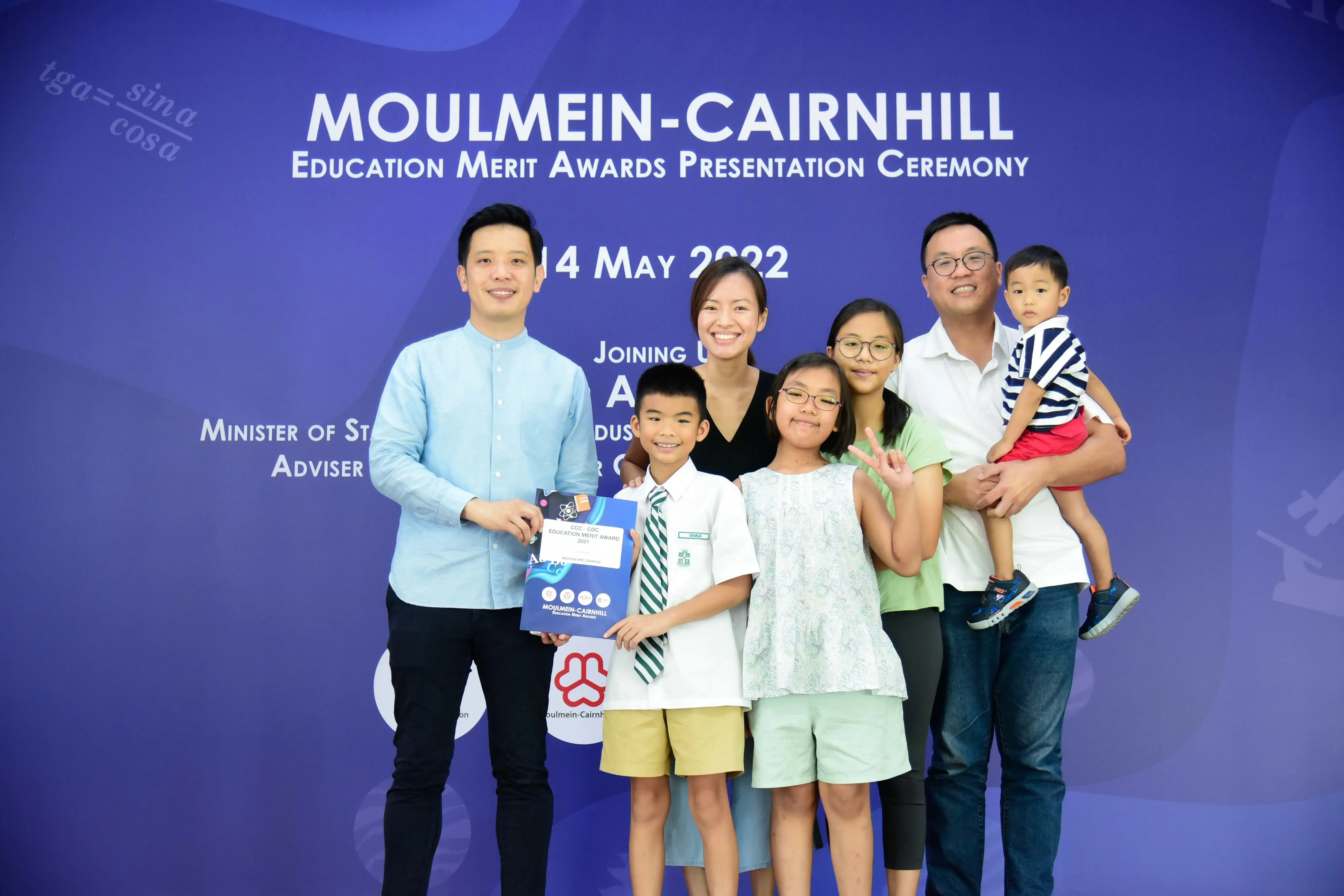 A family of adults and children pose at the Moulmein-Cairnhill Education Merit Awards Ceremony on 14 May 2022.