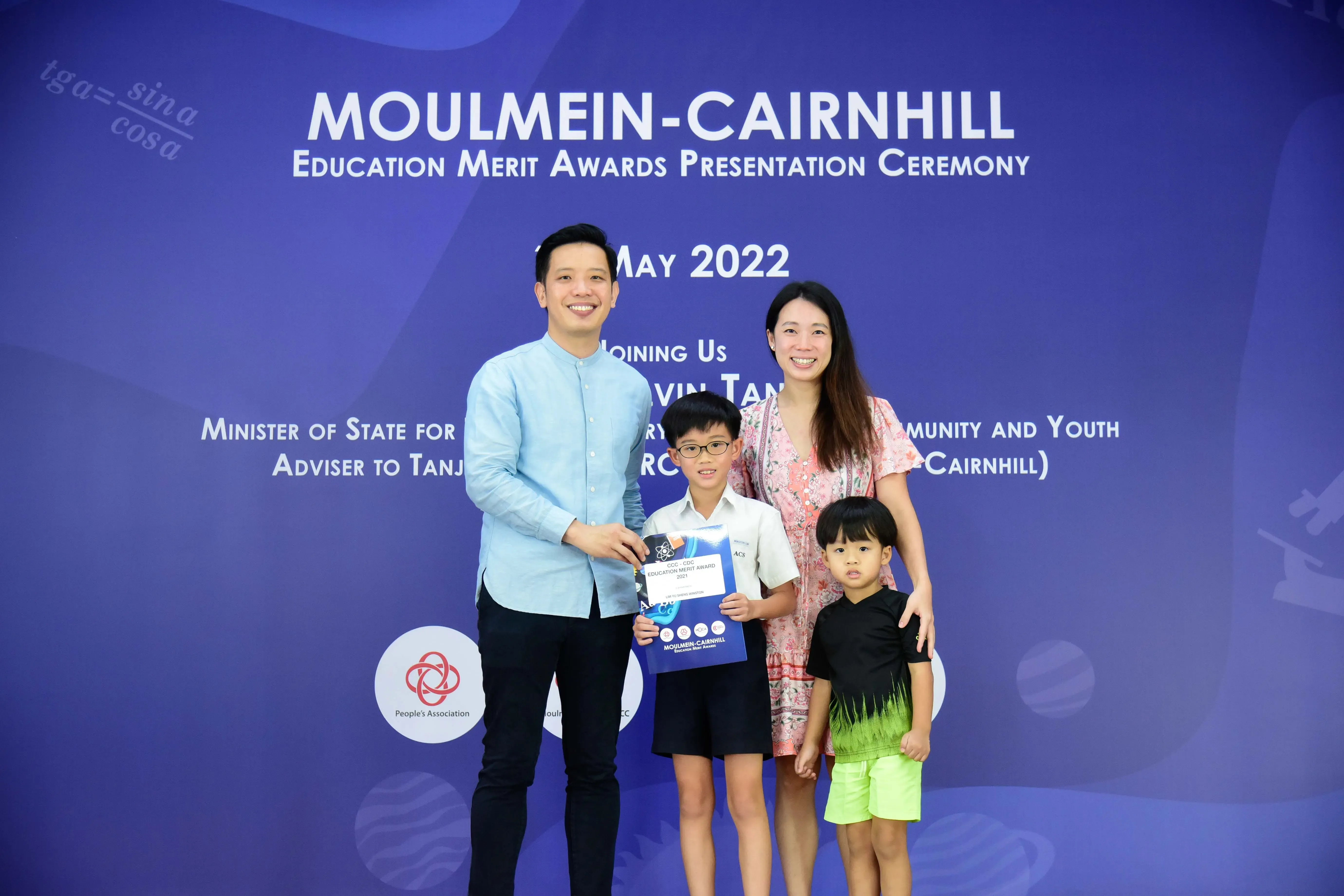 Family of four posing at Moulmein-Cairnhill Education Merit Awards Presentation Ceremony, May 2022.