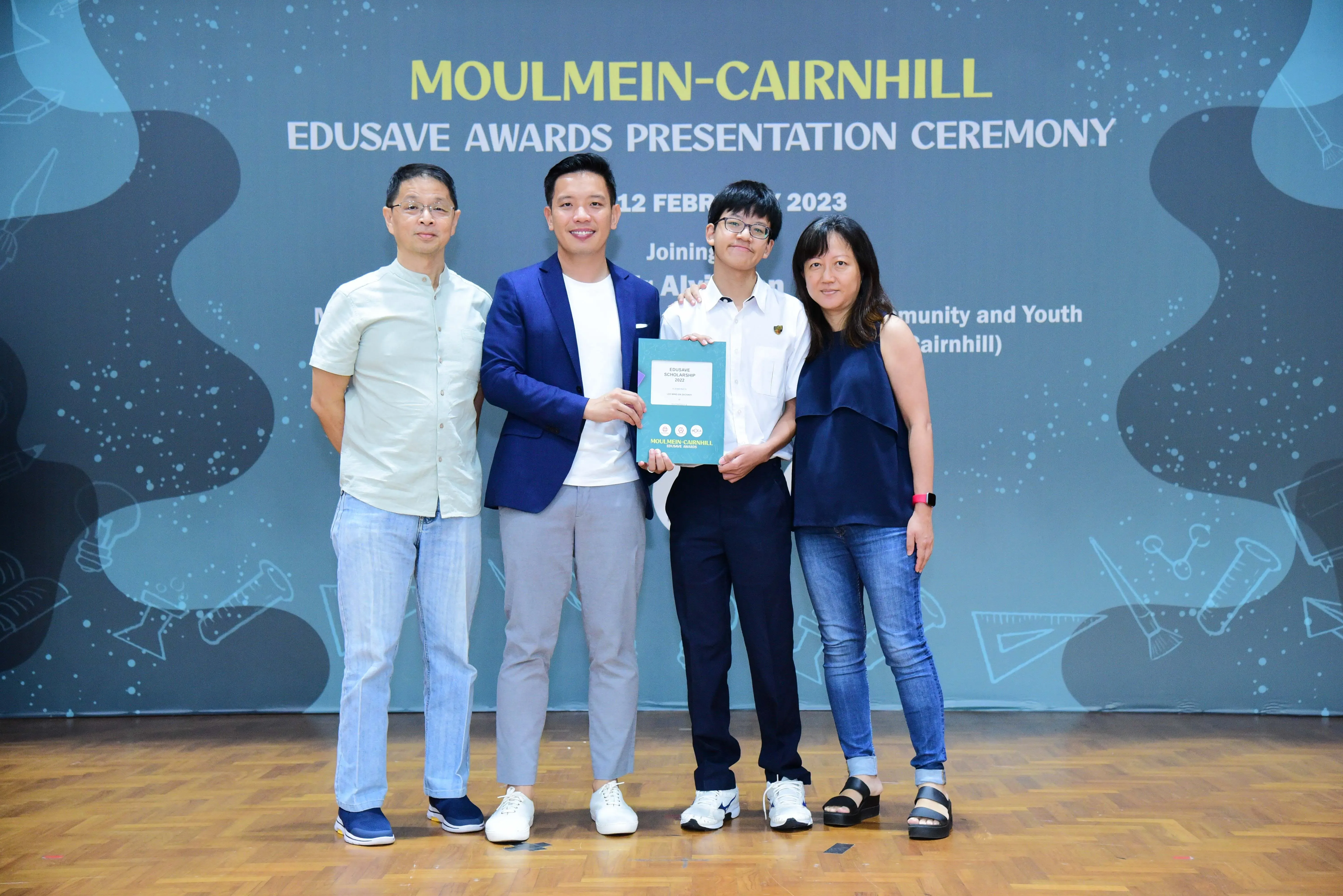 Four people posing at the Moulmein-Cairnhill Edusave Awards Presentation Ceremony on 12 February 2023.