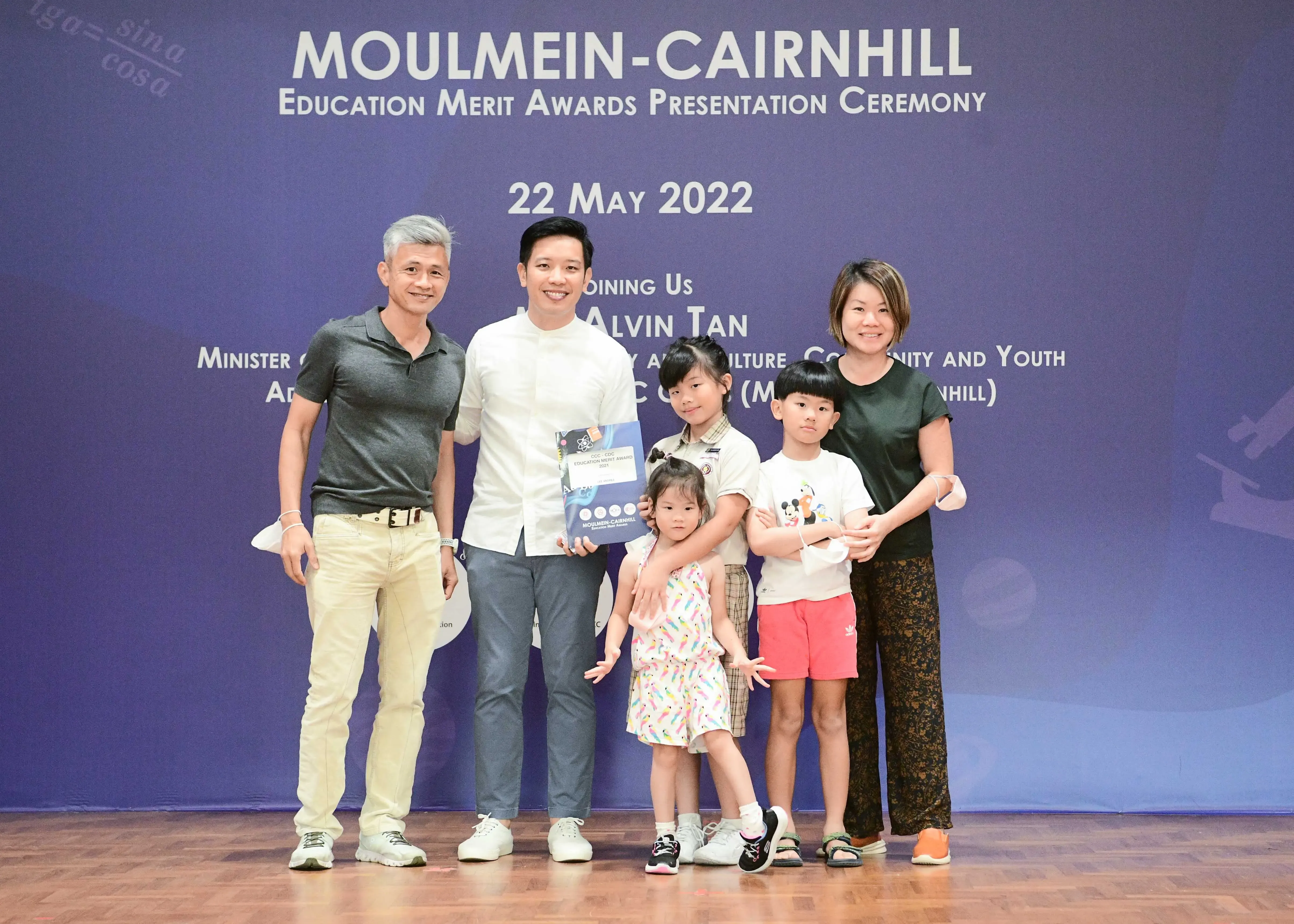 Two adults and three children pose at the Moulmein-Cairnhill Education Merit Awards Ceremony on 22 May 2022.