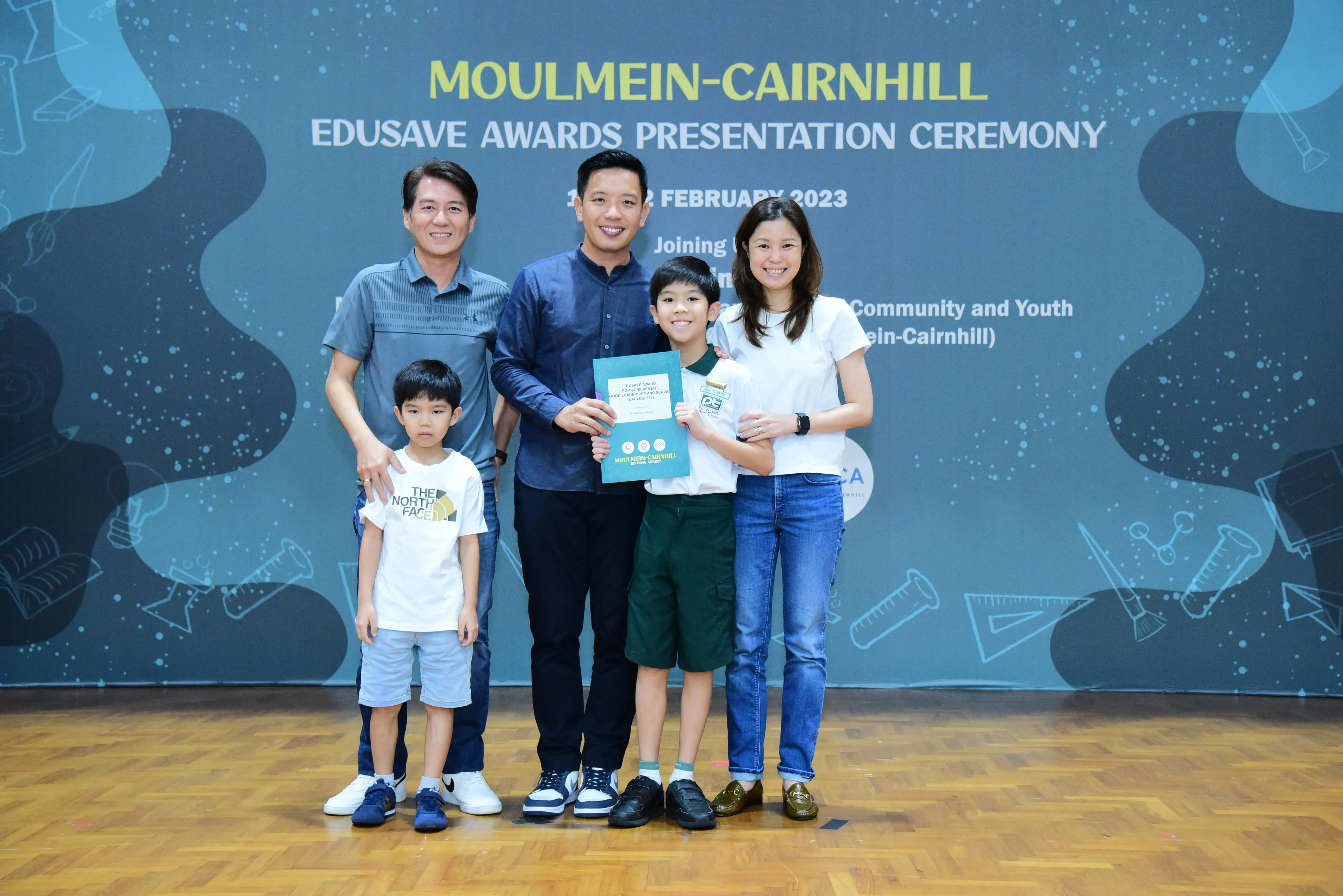 Five people pose together at the Moulmein-Cairnhill Edusave Awards Presentation Ceremony in February 2023.