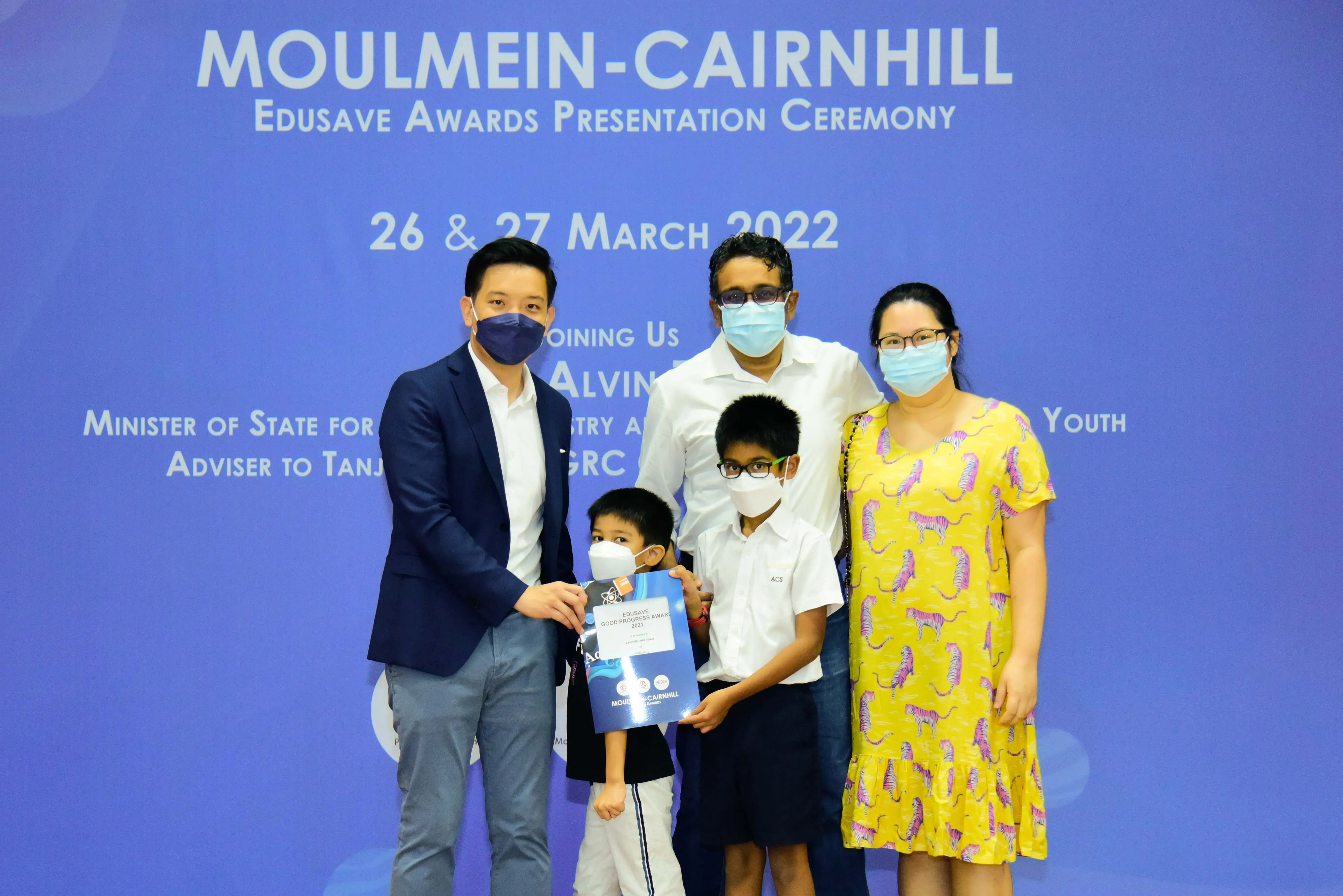 Five masked people pose at the Moulmein-Cairnhill Edusave Awards Ceremony on 26-27 March 2022.