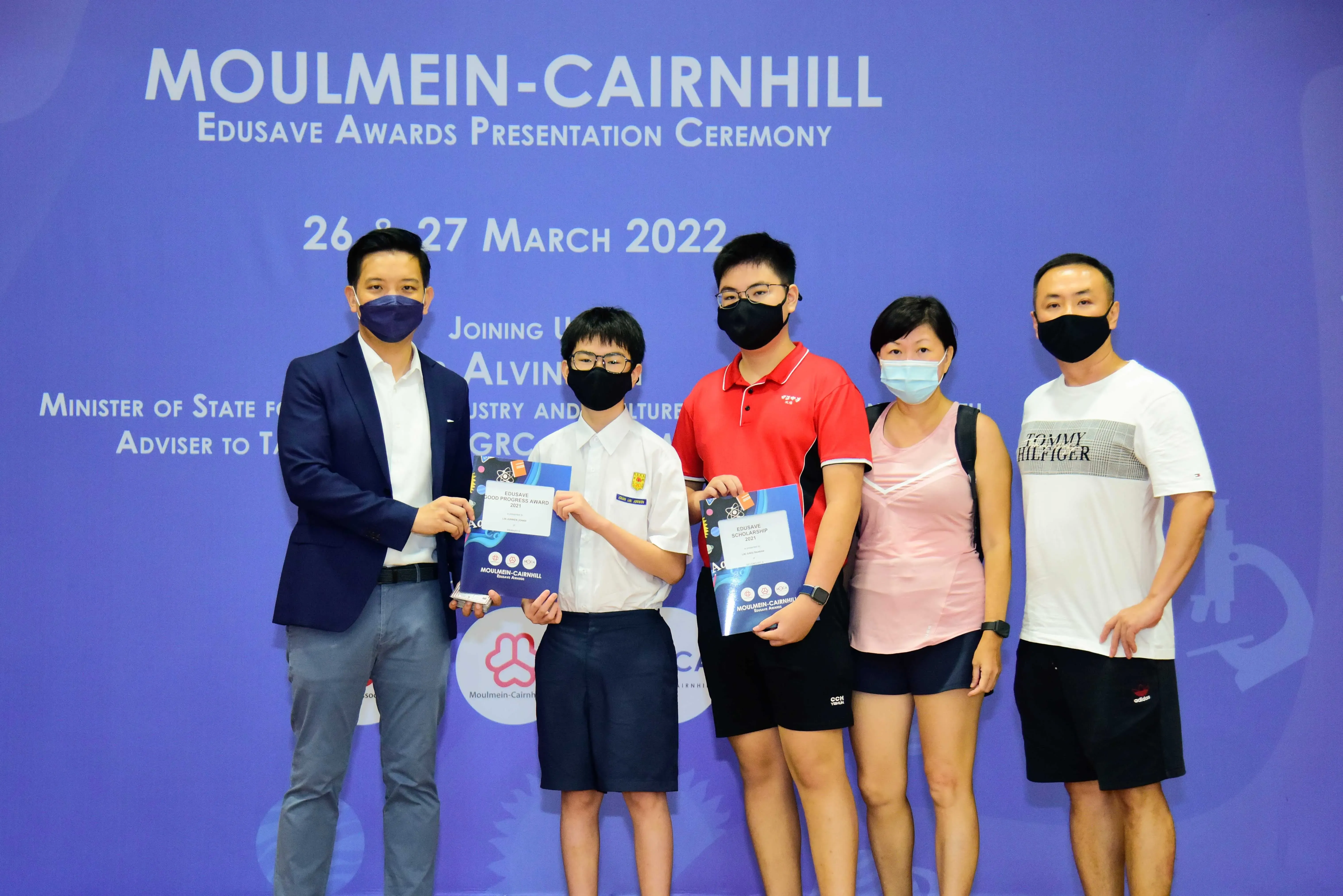 Five masked people pose at the Moulmein-Cairnhill Edusave Awards Presentation Ceremony on 26-27 March 2022.