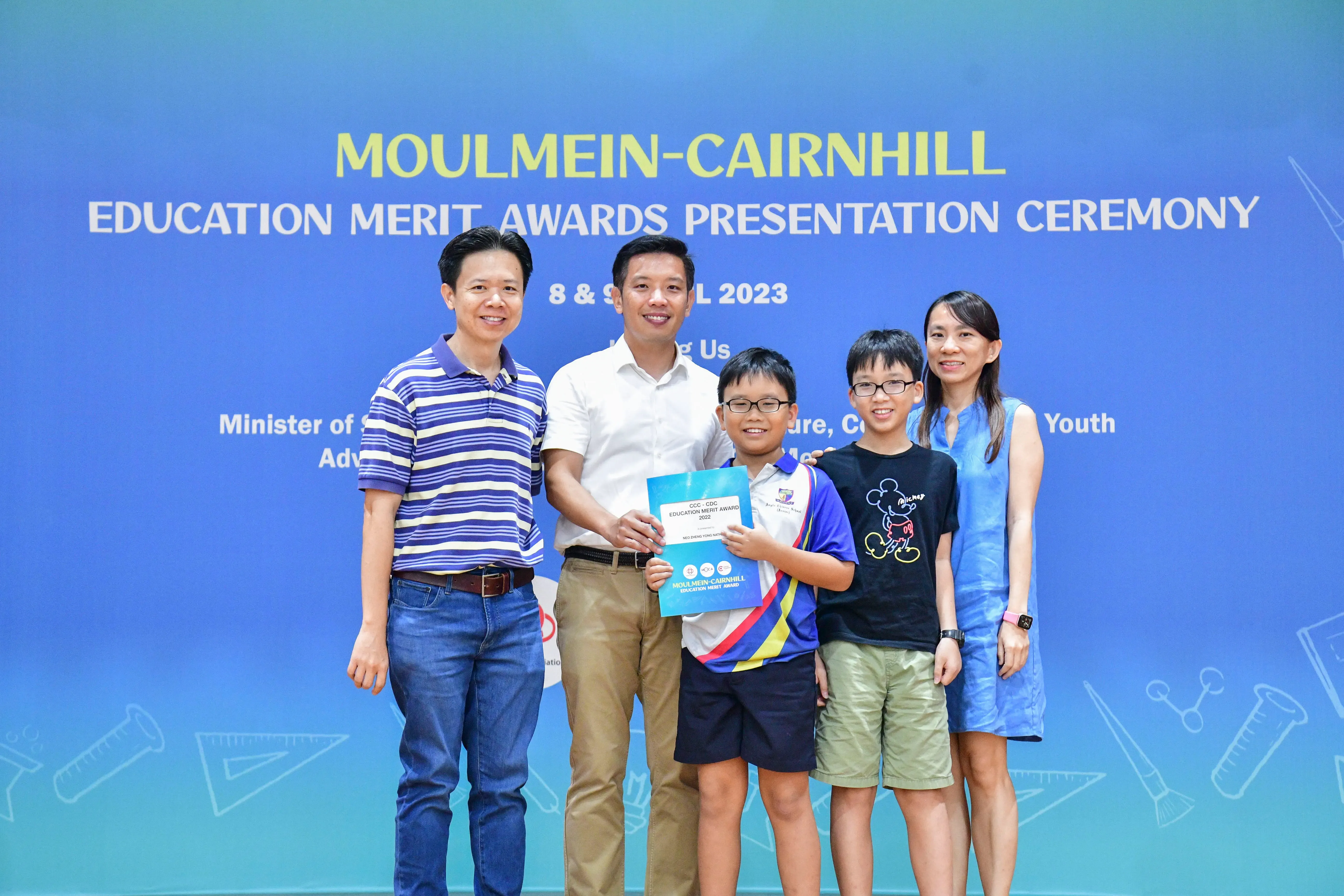 Five people pose together at the Moulmein-Cairnhill Education Merit Awards Presentation Ceremony 2023.