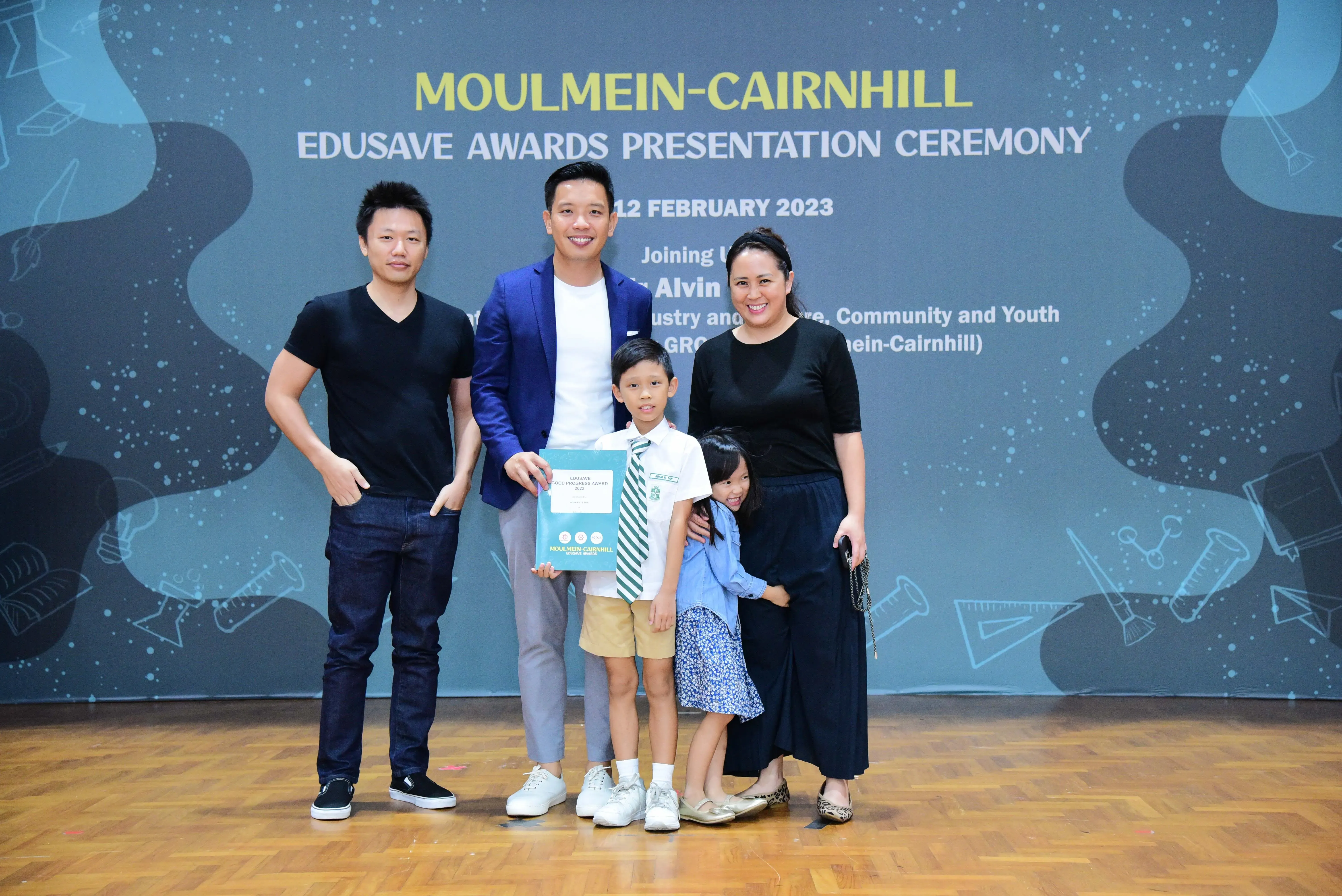 Family of five poses at the Moulmein-Cairnhill Edusave Awards Presentation Ceremony on 12 February 2023.