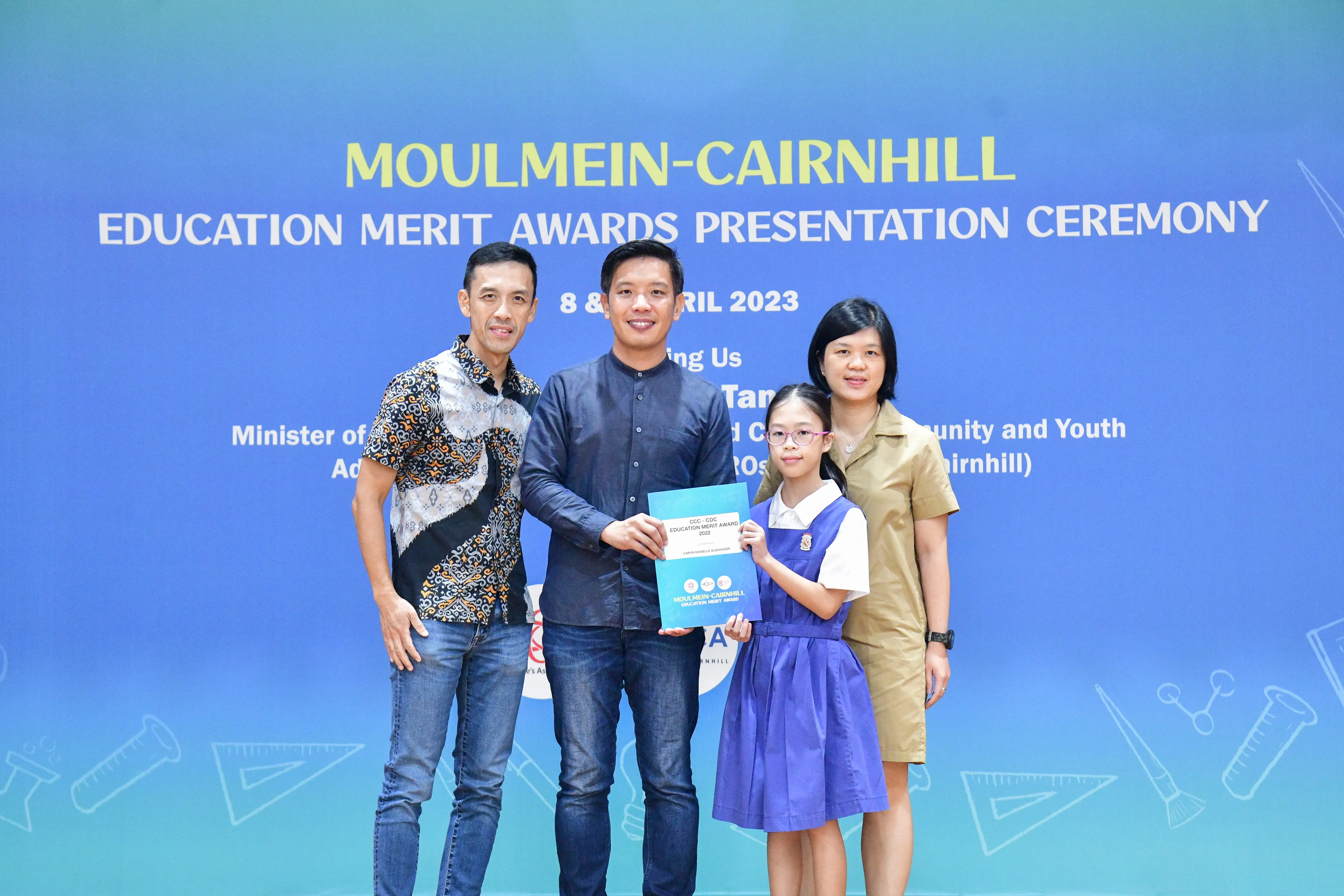 Four people pose at the Moulmein-Cairnhill Education Merit Awards Presentation Ceremony in April 2023.