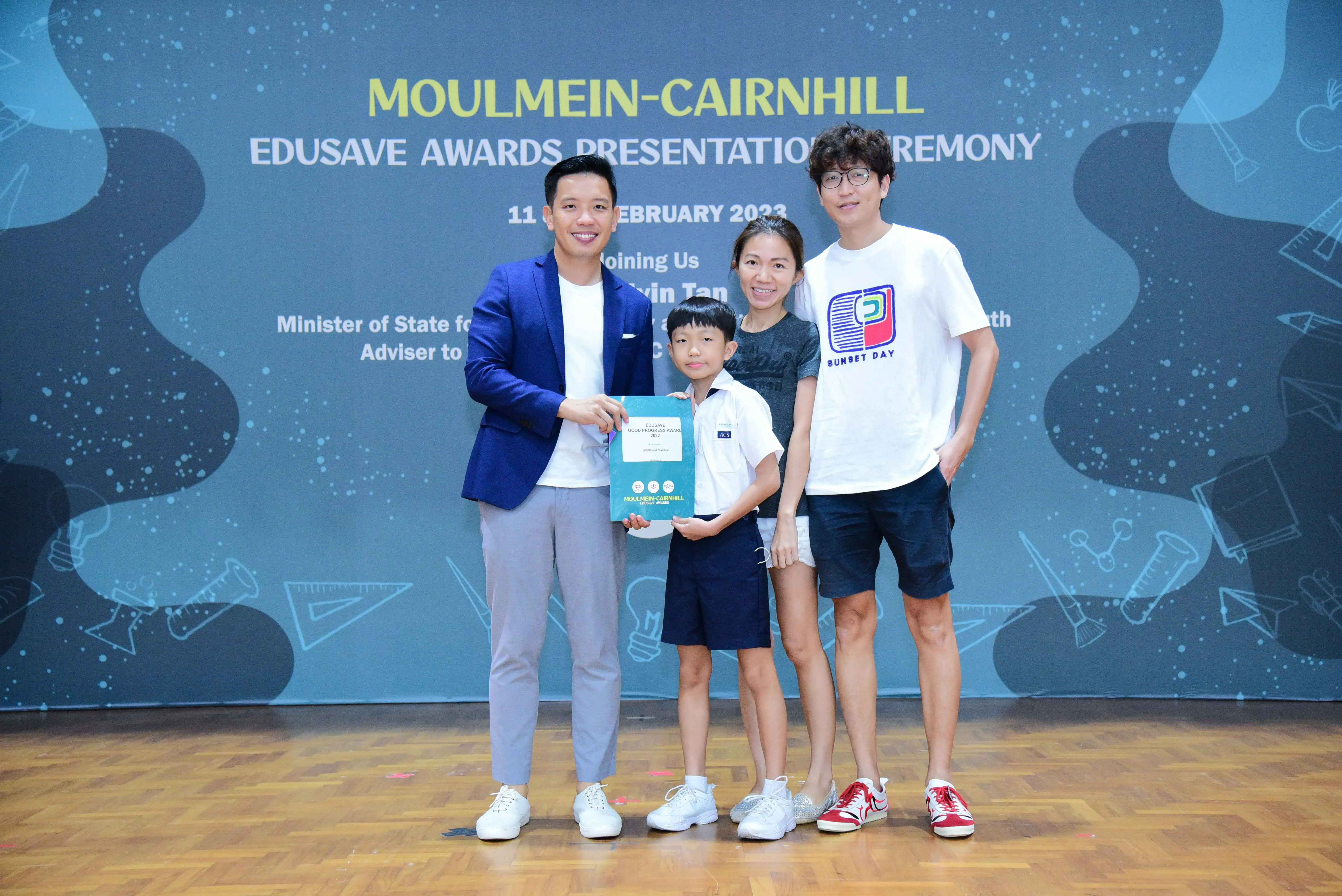 Four people pose with an award at the Moulmein-Cairnhill Edusave Awards Presentation Ceremony in February 2023.