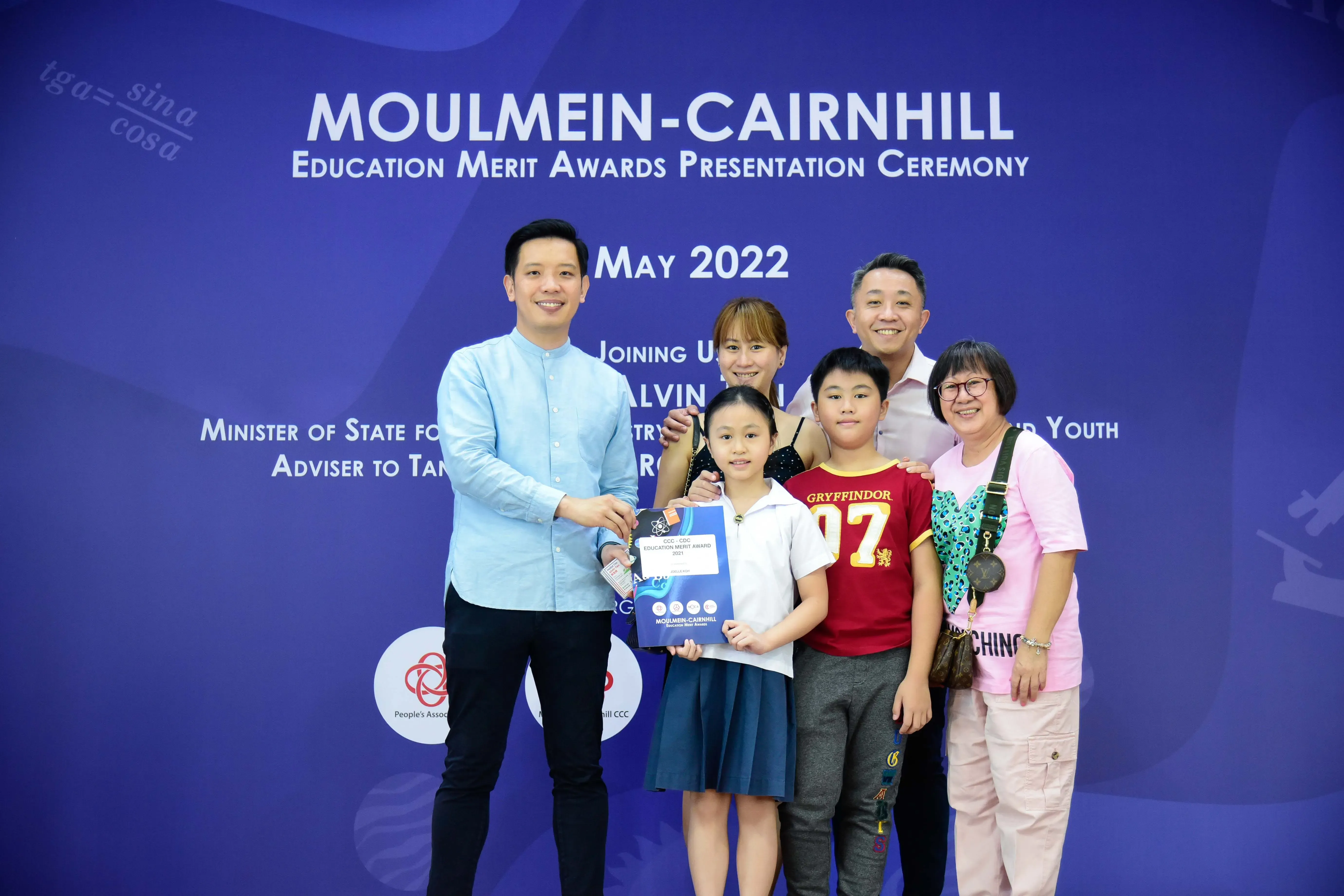 Group of six people posing at the Moulmein-Cairnhill Education Merit Awards ceremony in May 2022.