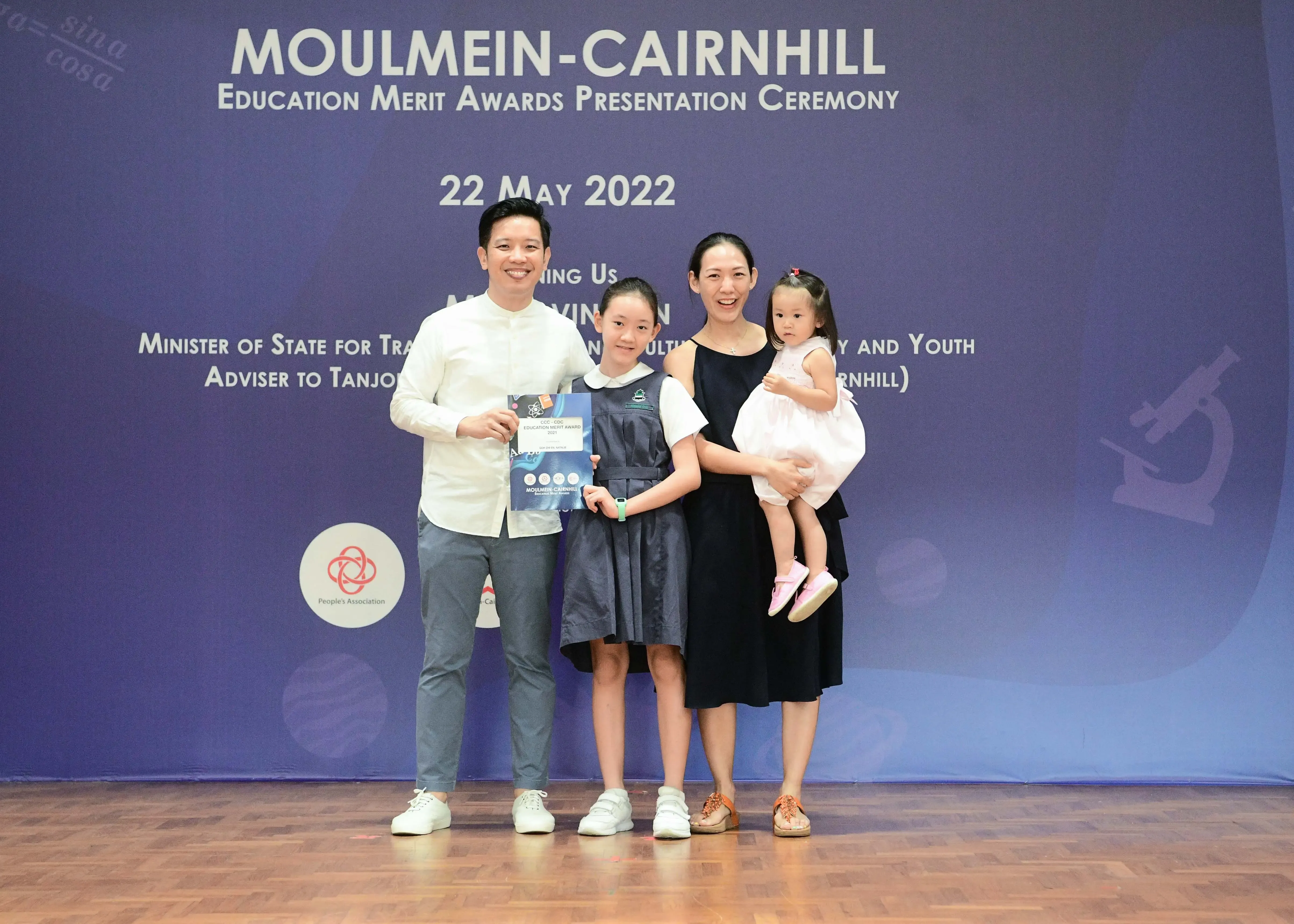 Family of four posing at the Moulmein-Cairnhill Education Merit Awards Presentation Ceremony on 22 May 2022.