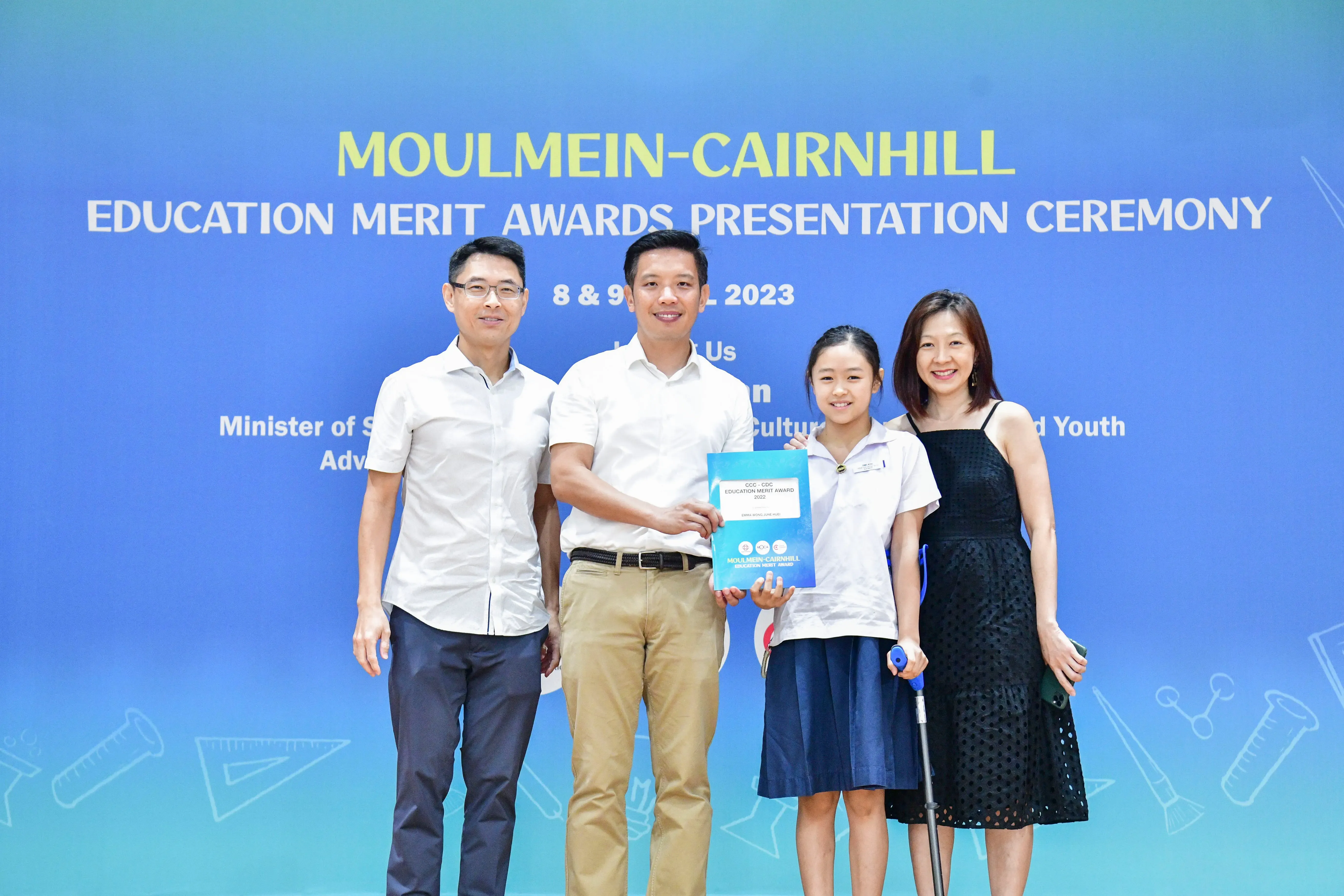 Four people pose at the Moulmein-Cairnhill Education Merit Awards Presentation Ceremony in 2023.