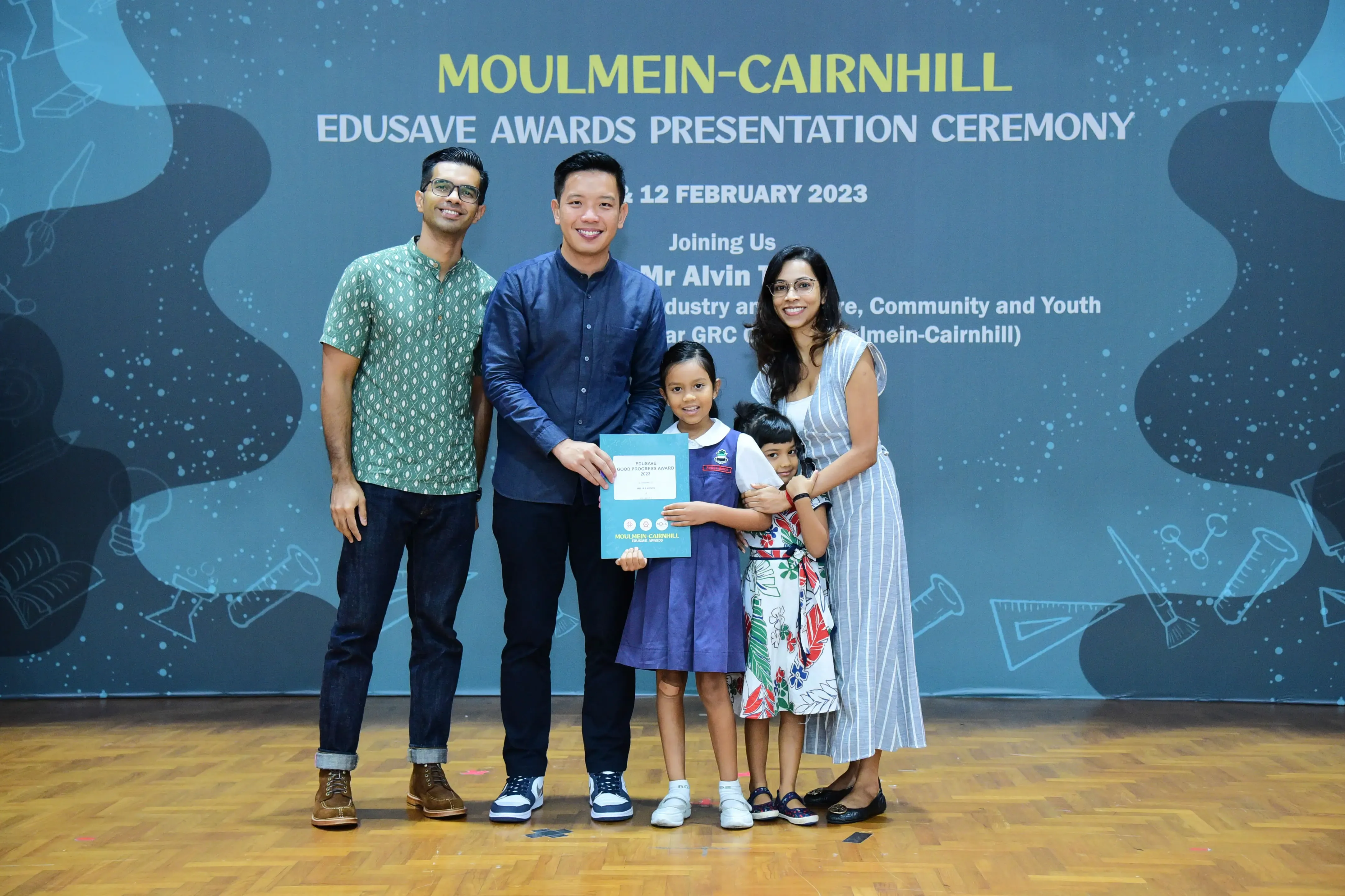 Five people pose with a certificate at the Moulmein-Cairnhill Edusave Awards Presentation Ceremony on 12 February 2023.