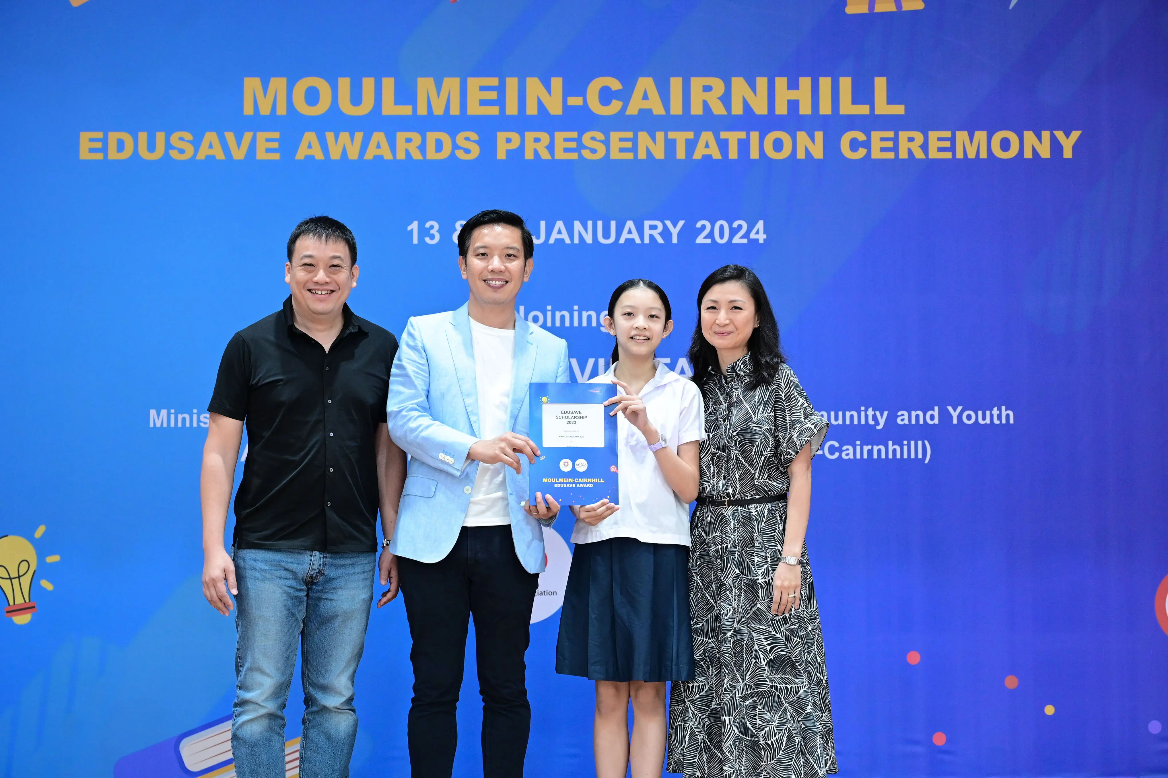 Four people pose at the Moulmein-Cairnhill Edusave Awards Presentation Ceremony on 13 January 2024.