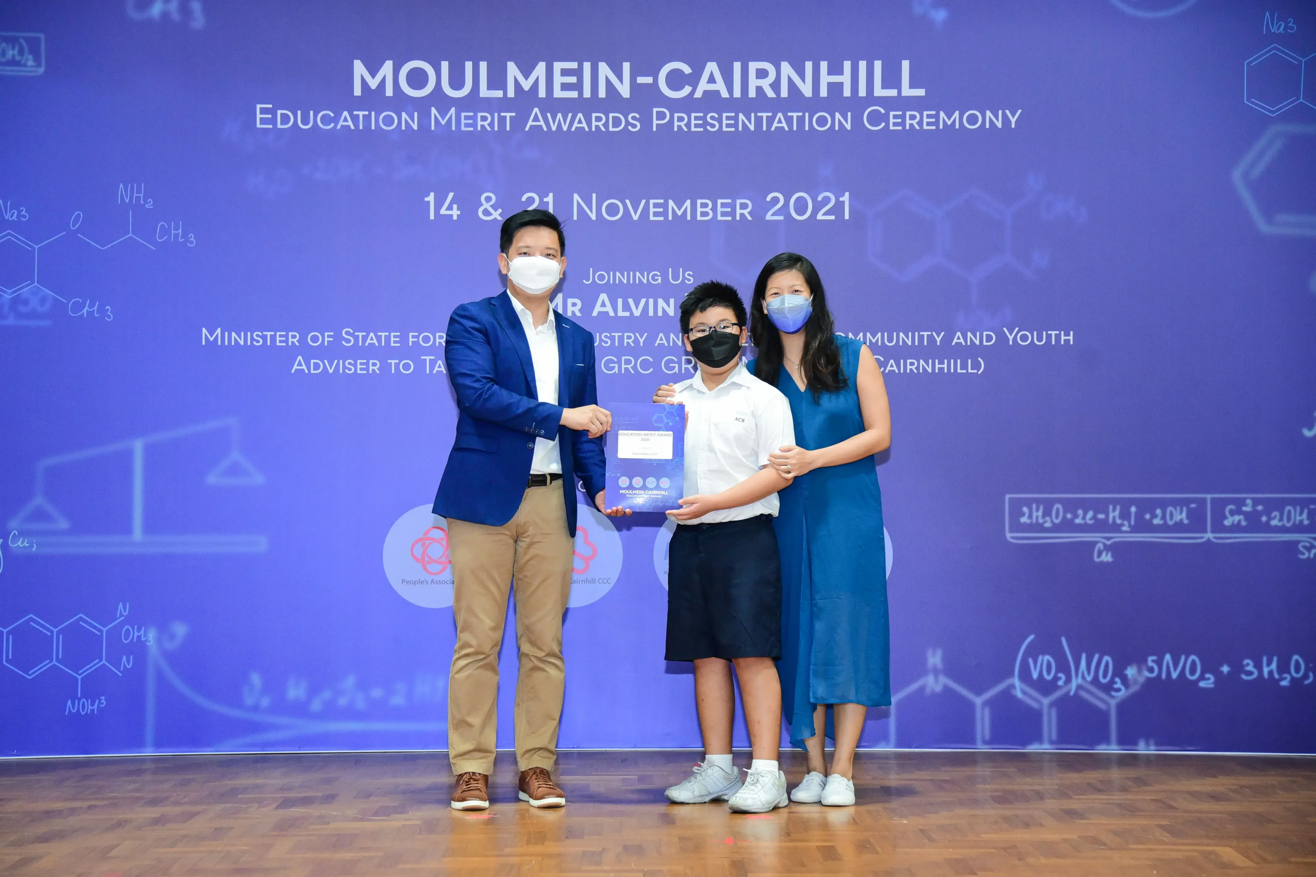 Three masked people pose at the Moulmein-Cairnhill Education Merit Awards Ceremony on 14 & 21 November 2021.