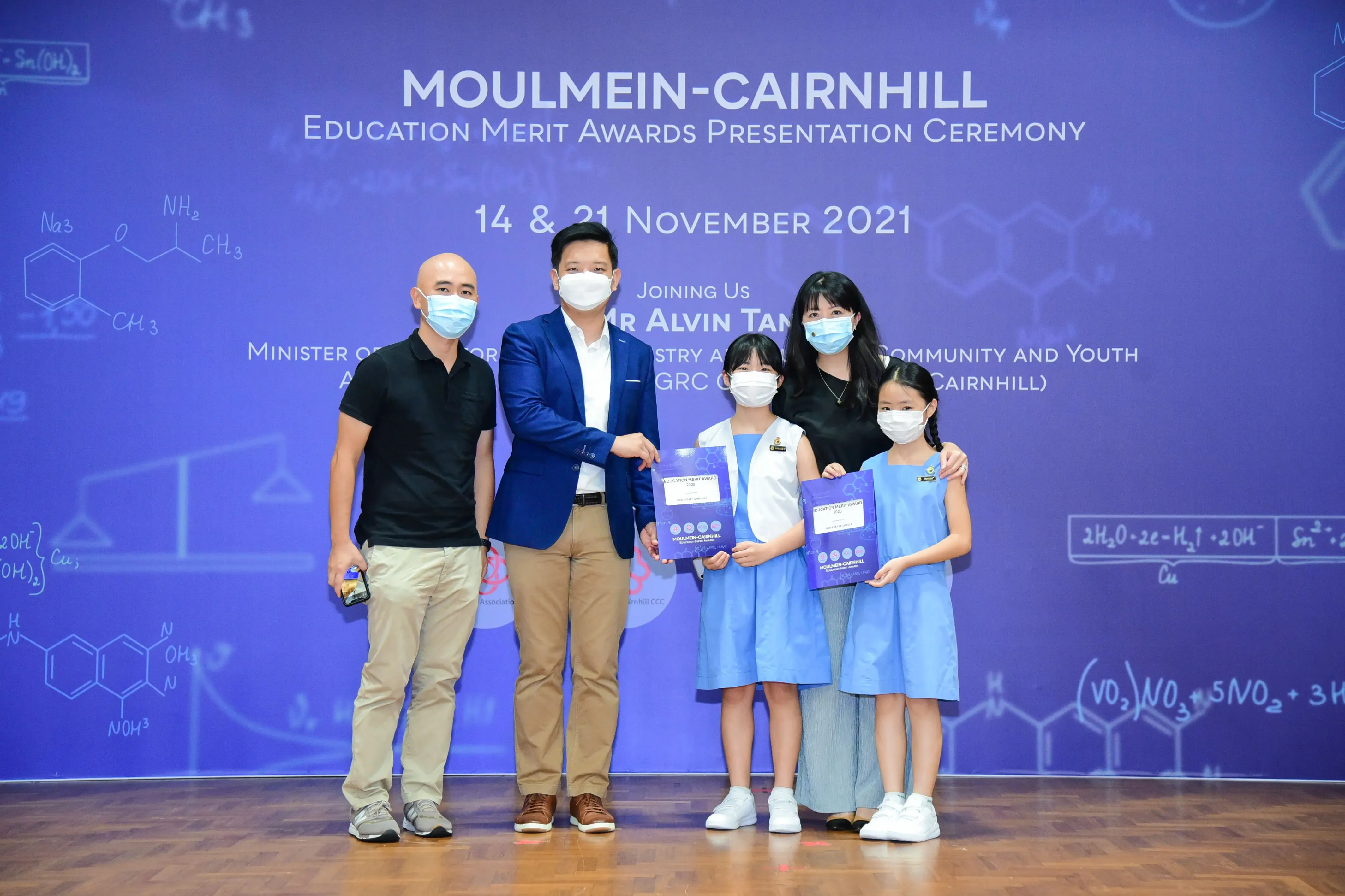 Five masked people pose at the Moulmein-Cairnhill Education Merit Awards Ceremony on 14 & 21 November 2021.