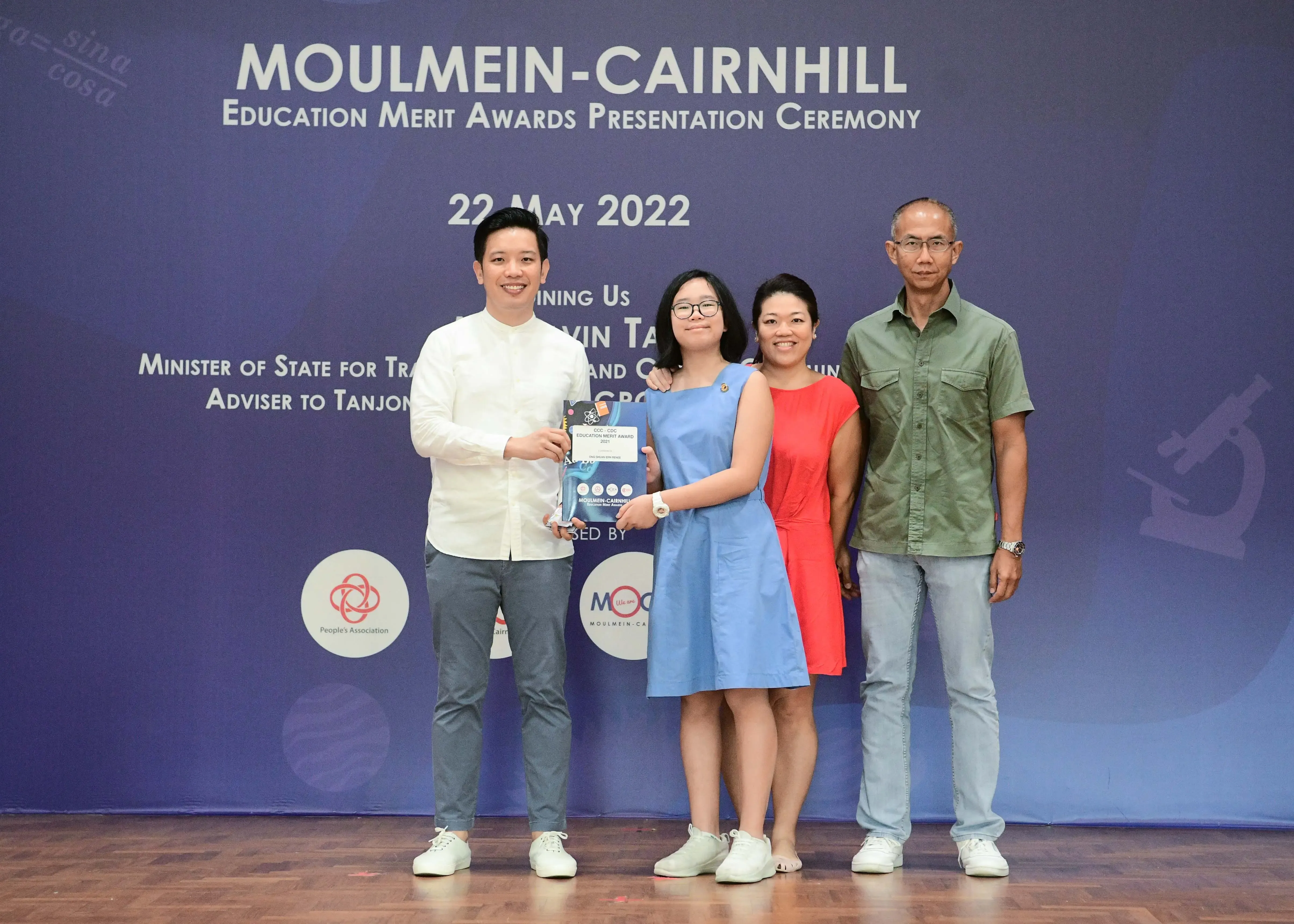 Four people pose holding an award at the Moulmein-Cairnhill Education Merit Awards Presentation Ceremony on 22 May 2022.
