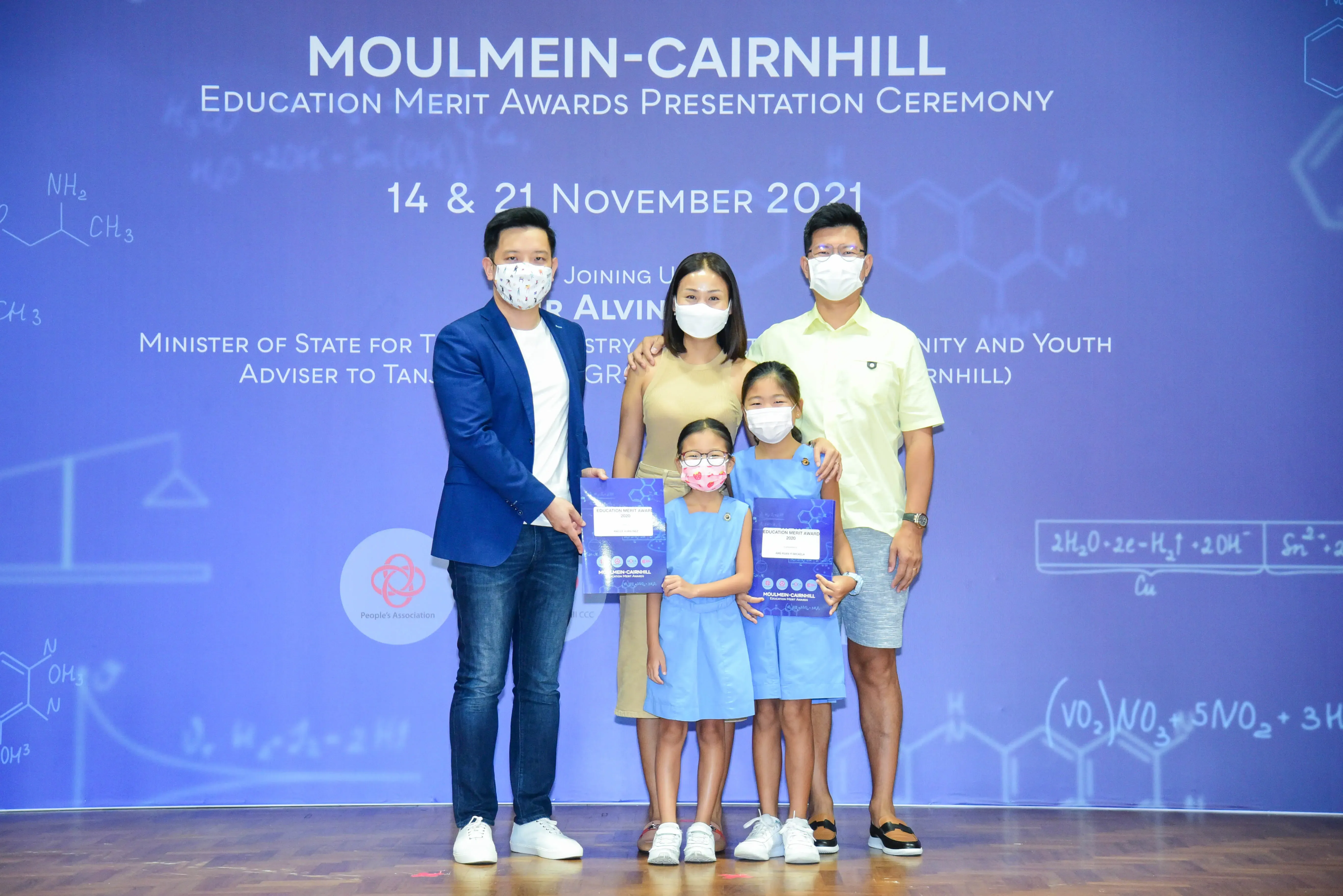 Five masked people pose at the Moulmein-Cairnhill Education Merit Awards Presentation Ceremony, November 2021.