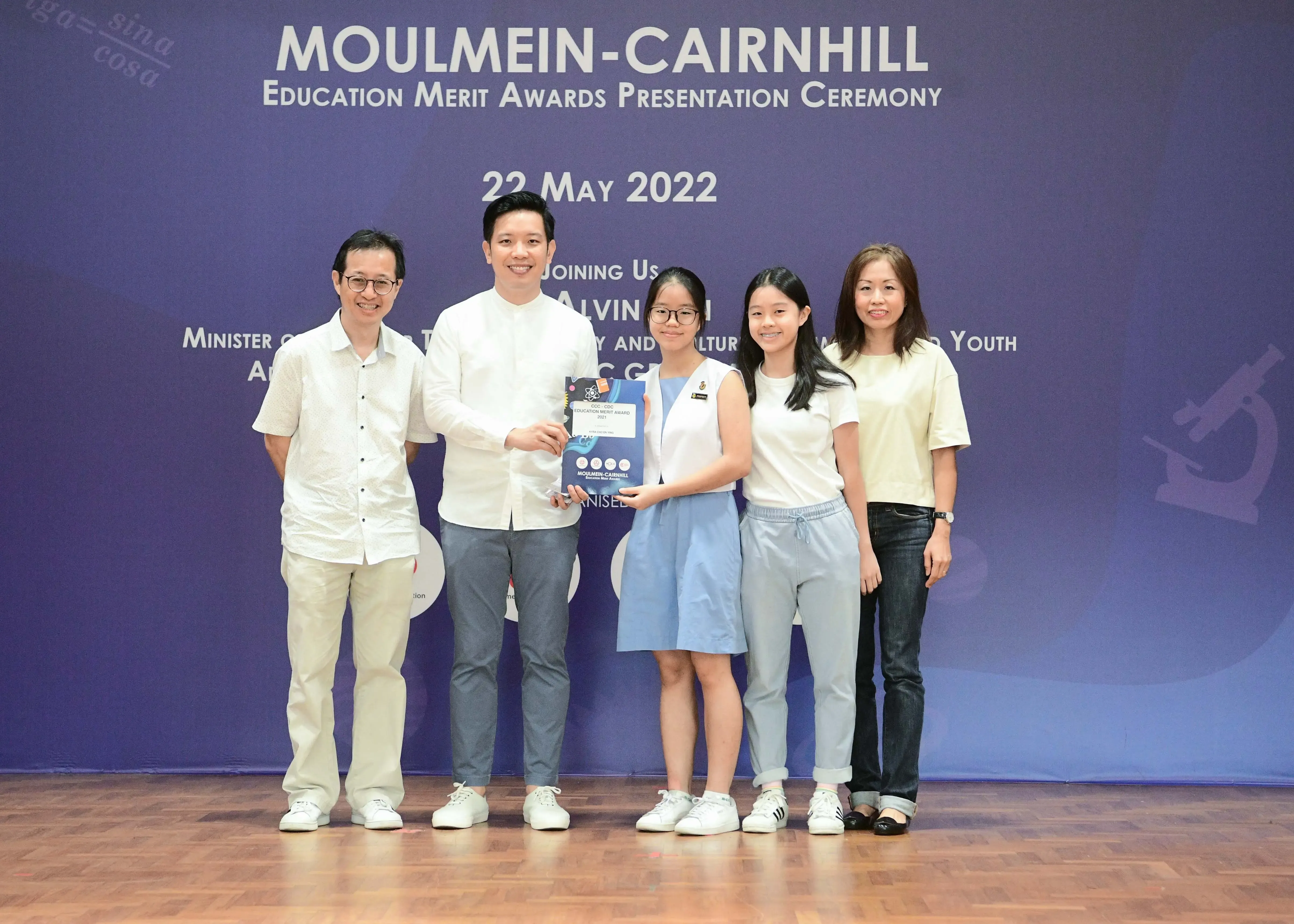 Five people pose together at the Moulmein-Cairnhill Education Merit Awards Presentation Ceremony on 22 May 2022.