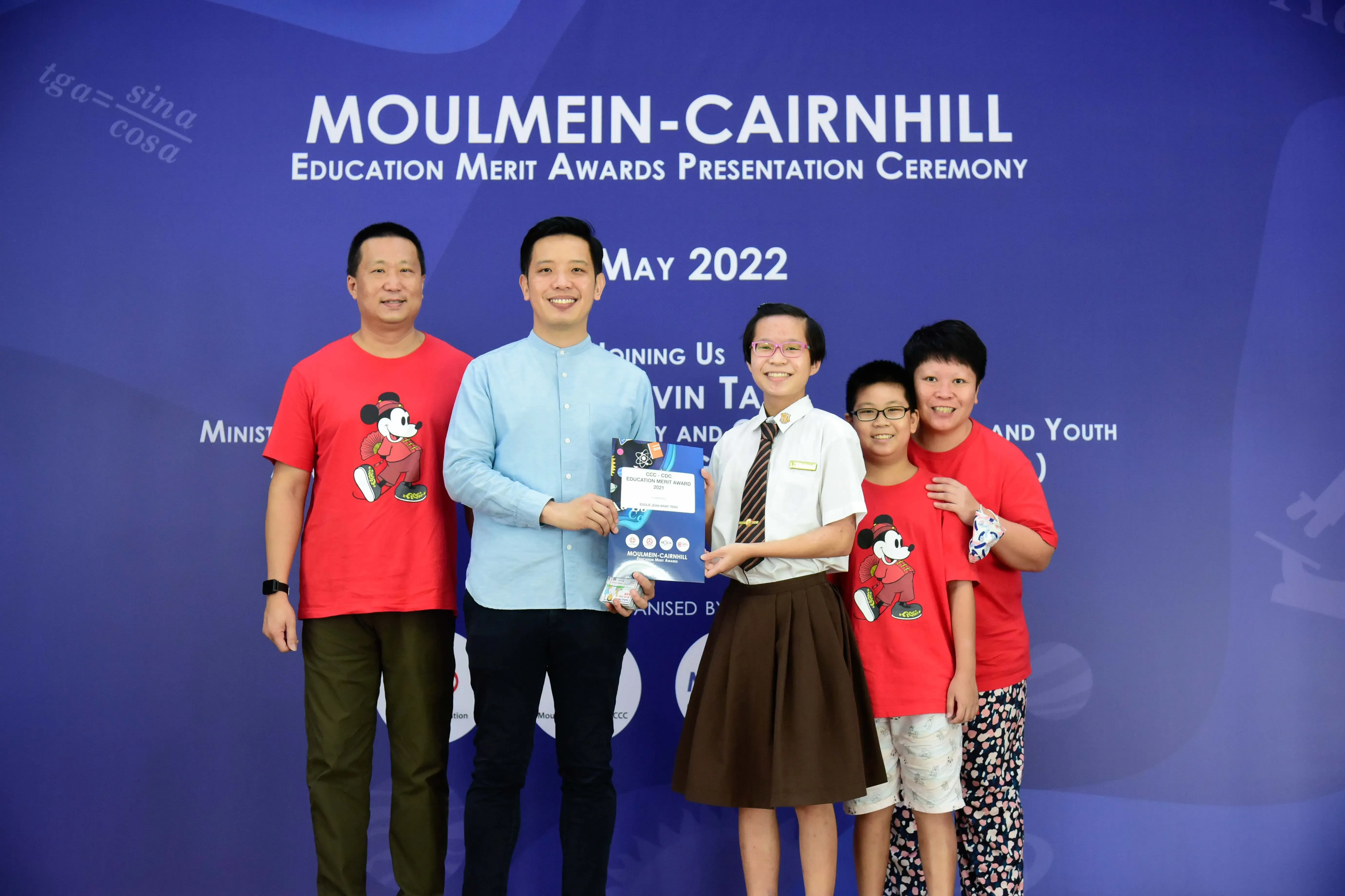Five people pose at the Moulmein-Cairnhill Education Merit Awards Presentation Ceremony in May 2022.