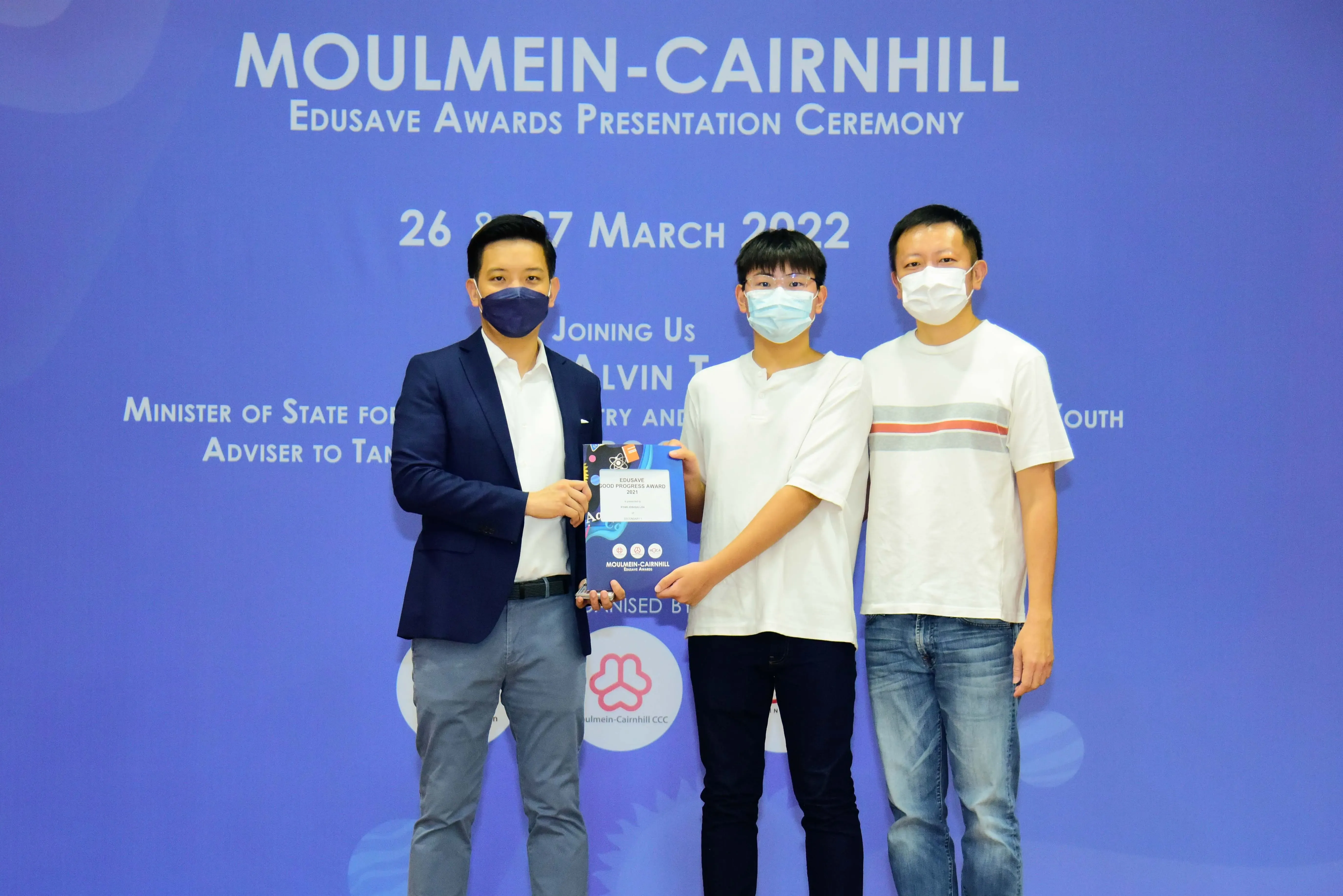 Three masked people pose at the Moulmein-Cairnhill Edusave Awards Presentation Ceremony on 26-27 March 2022.