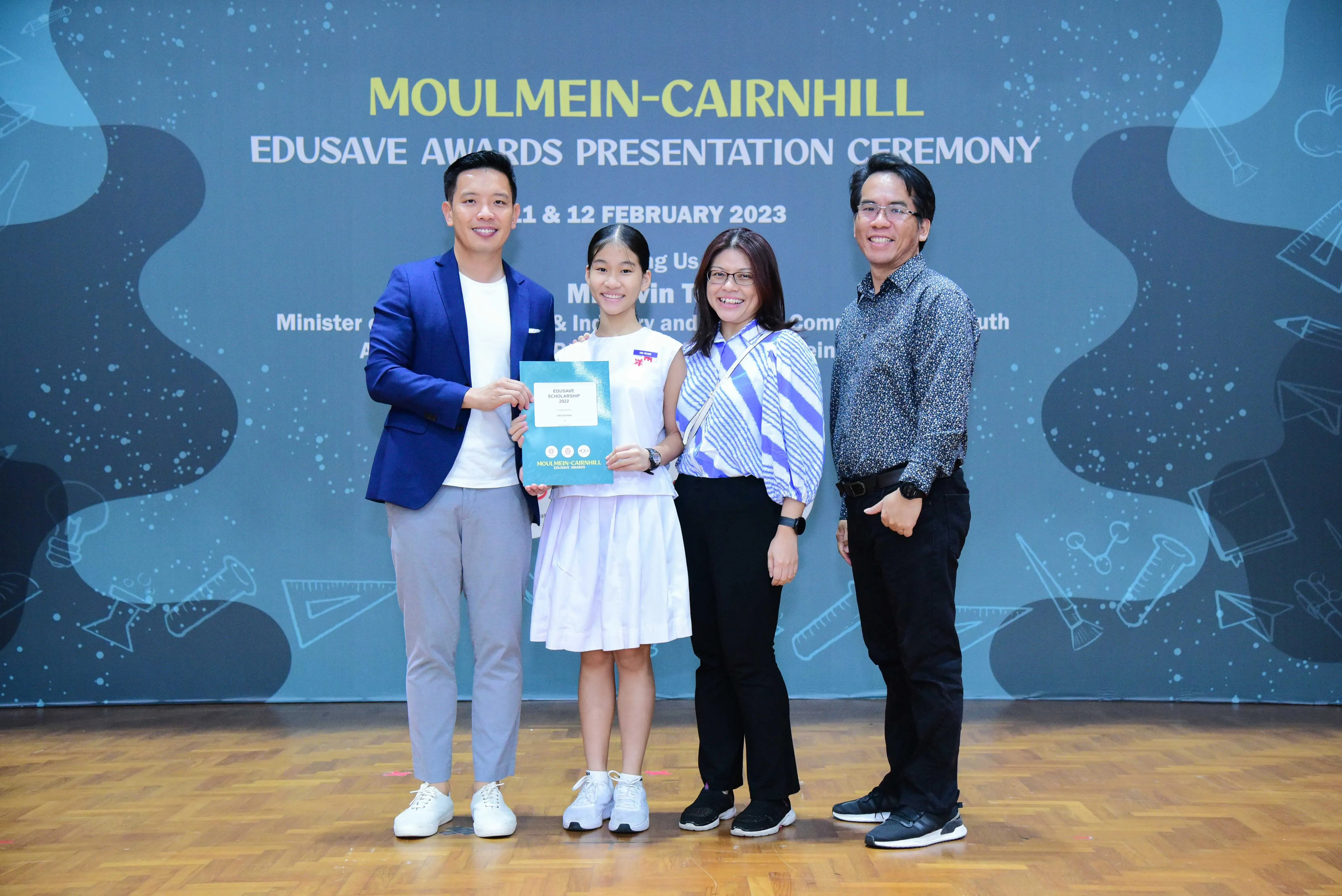 Four people pose at the Moulmein-Cairnhill Edusave Awards Presentation Ceremony on 11-12 February 2023.