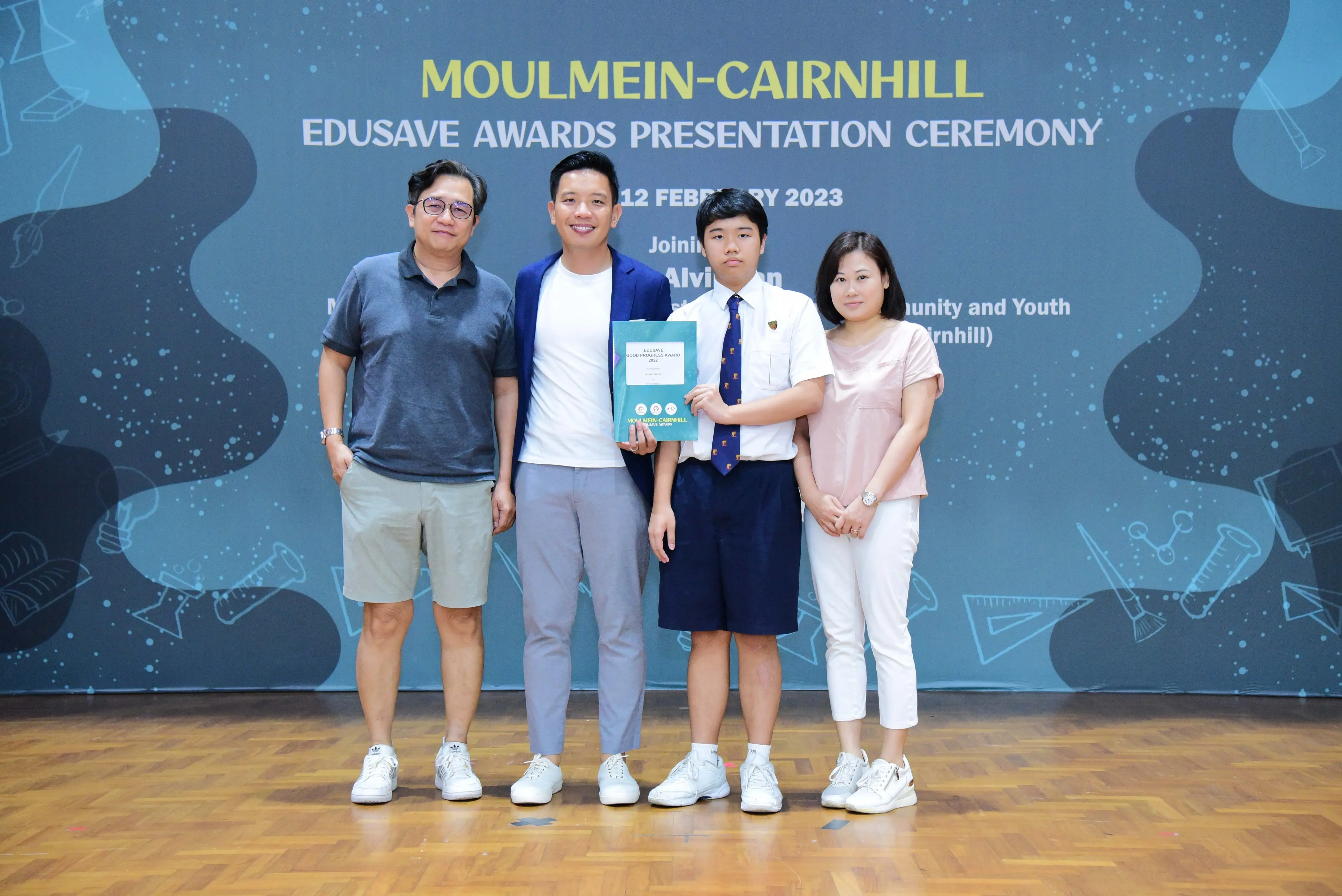 Four people pose at the Moulmein-Cairnhill Edusave Awards Presentation Ceremony on 12 February 2023.