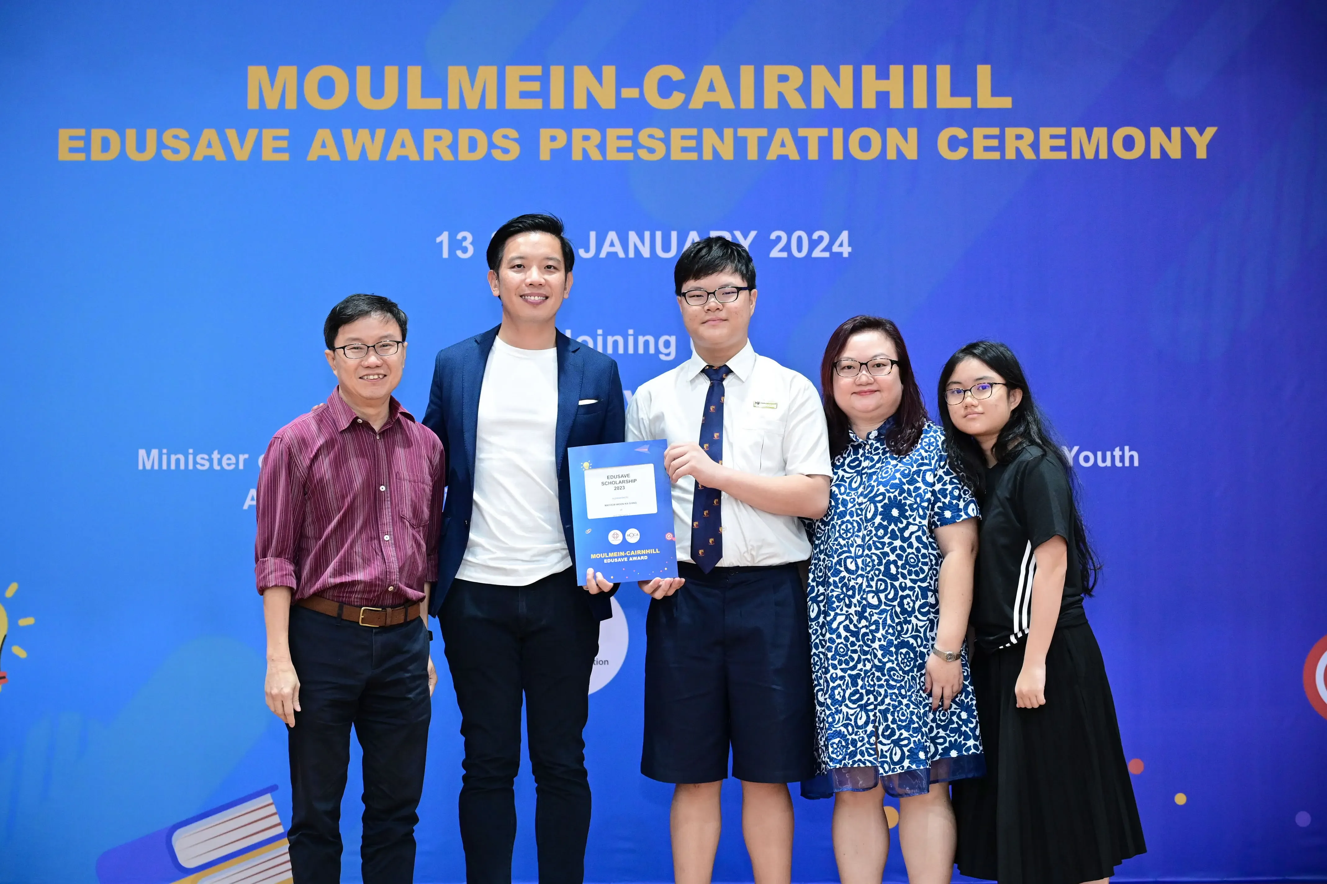 Five people pose at the Moulmein-Cairnhill Edusave Awards Presentation Ceremony on 13 January 2024.