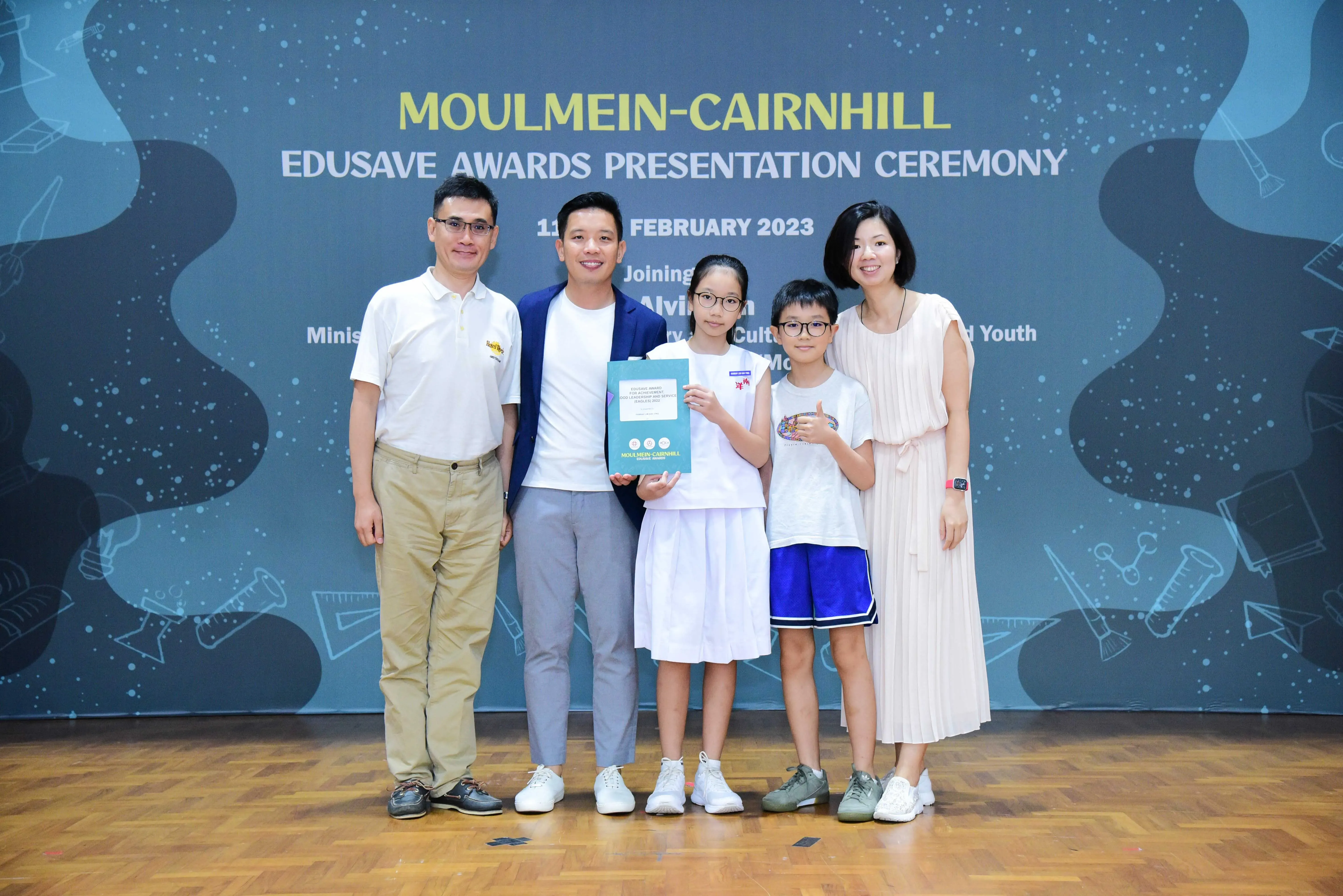 Five people pose at the Moulmein-Cairnhill Edusave Awards Presentation Ceremony in February 2023.