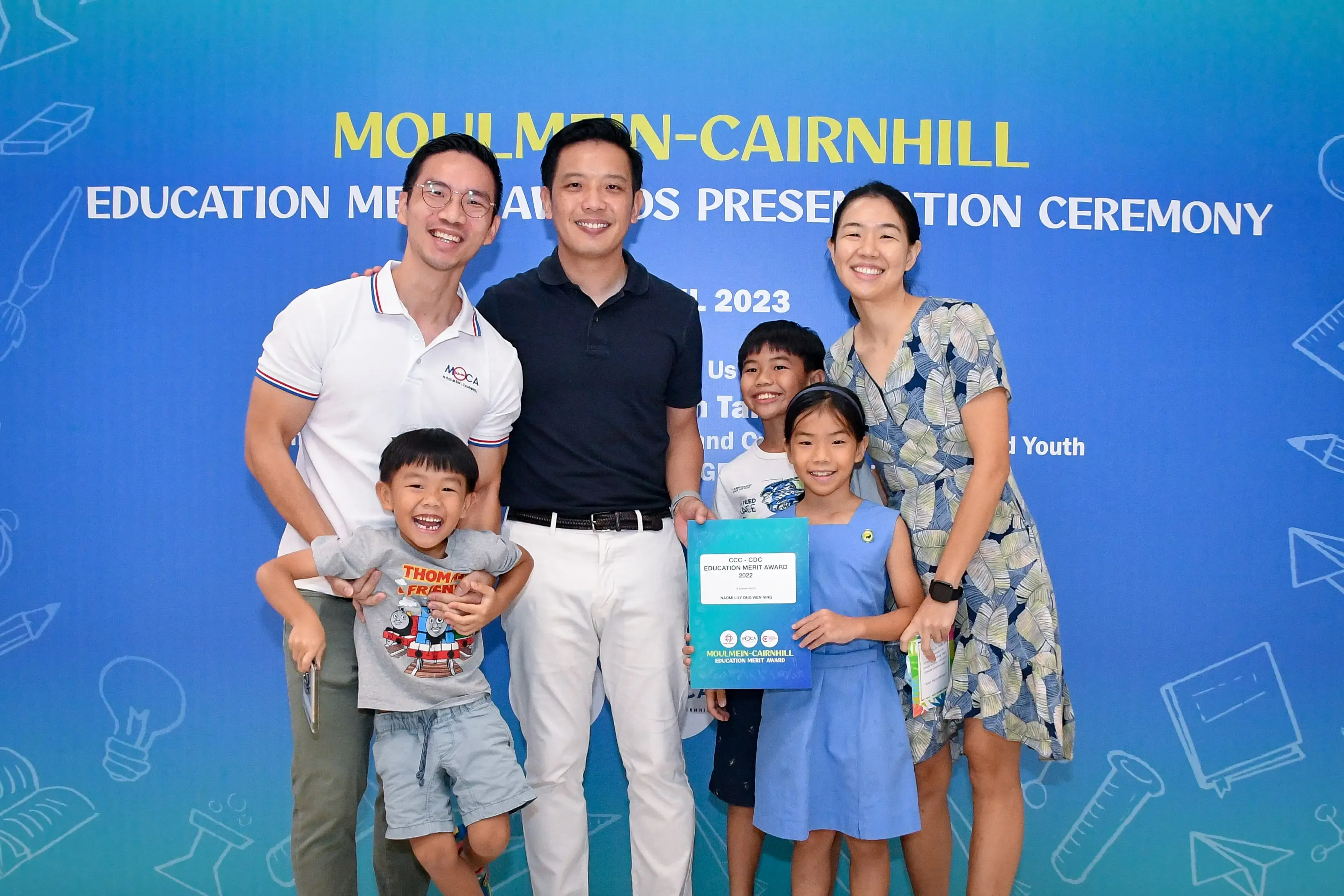 Two men, a woman, and three children pose at the 2023 Moulmein-Cairnhill Education Merit Awards ceremony.