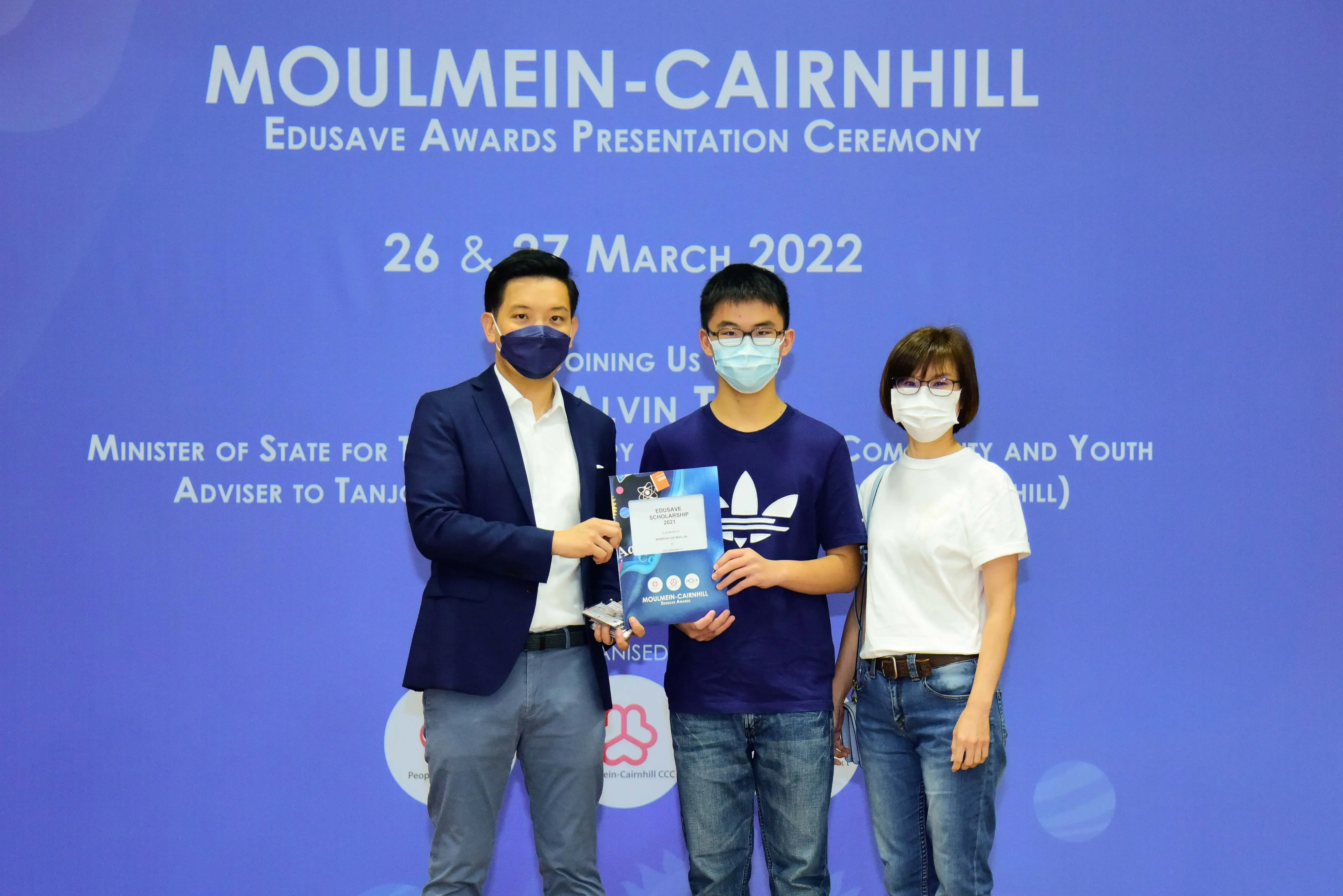 Three masked people pose at the Moulmein-Cairnhill Edusave Awards Presentation Ceremony on 26 & 27 March 2022.