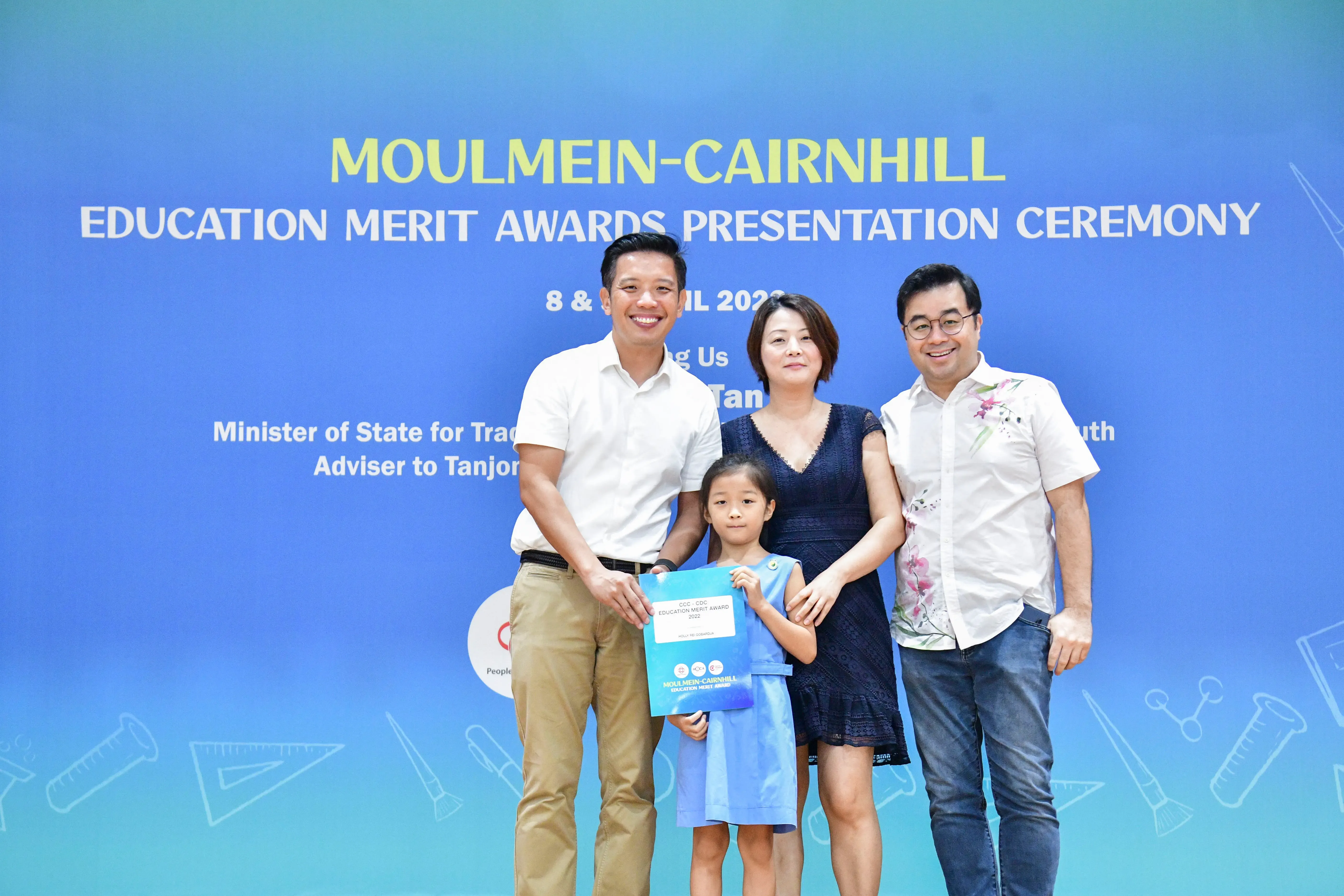 Three adults and a young girl pose at the Moulmein-Cairnhill Education Merit Awards Presentation Ceremony.