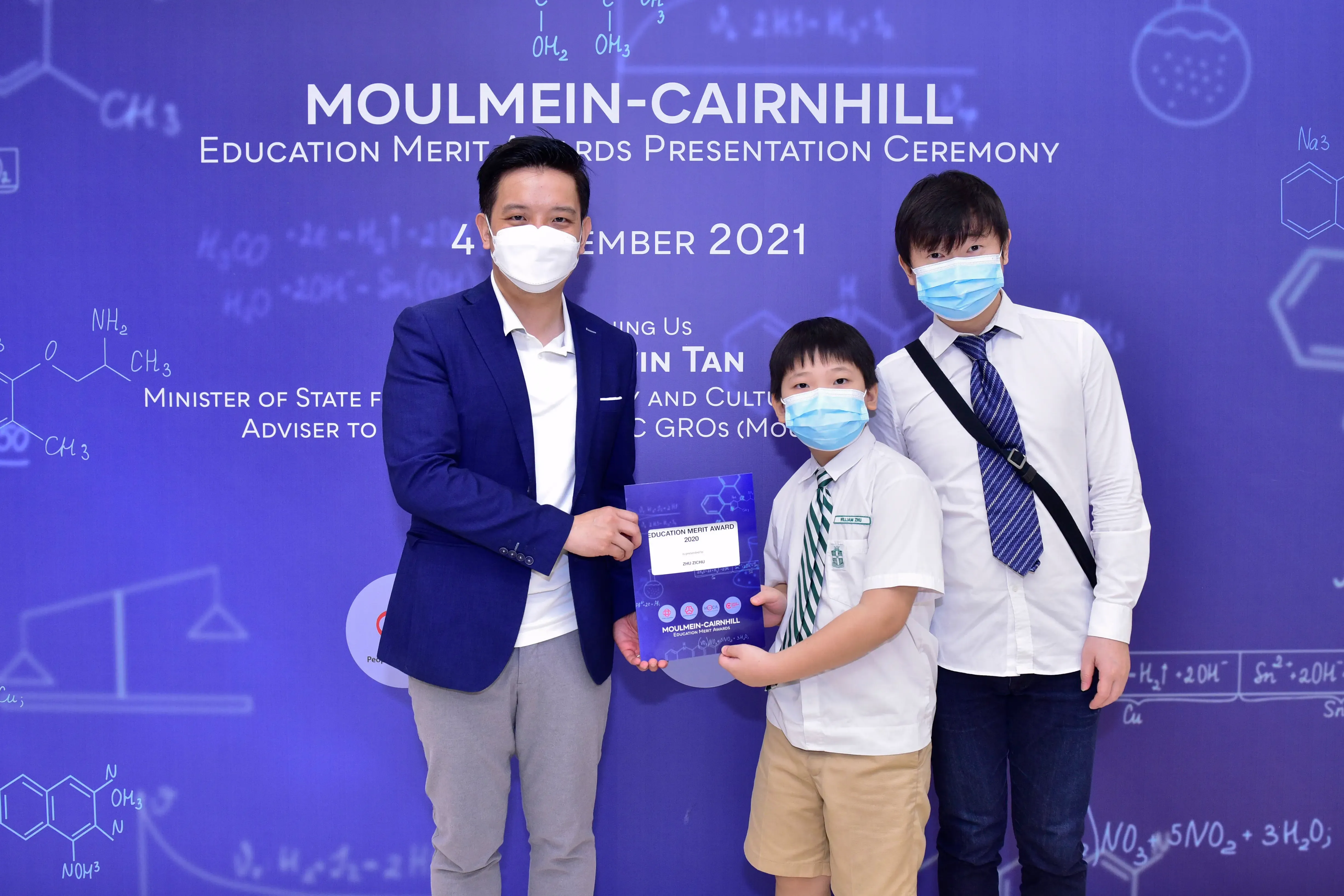 Three masked individuals pose at the Moulmein-Cairnhill Education Merit Awards Presentation Ceremony 2021.