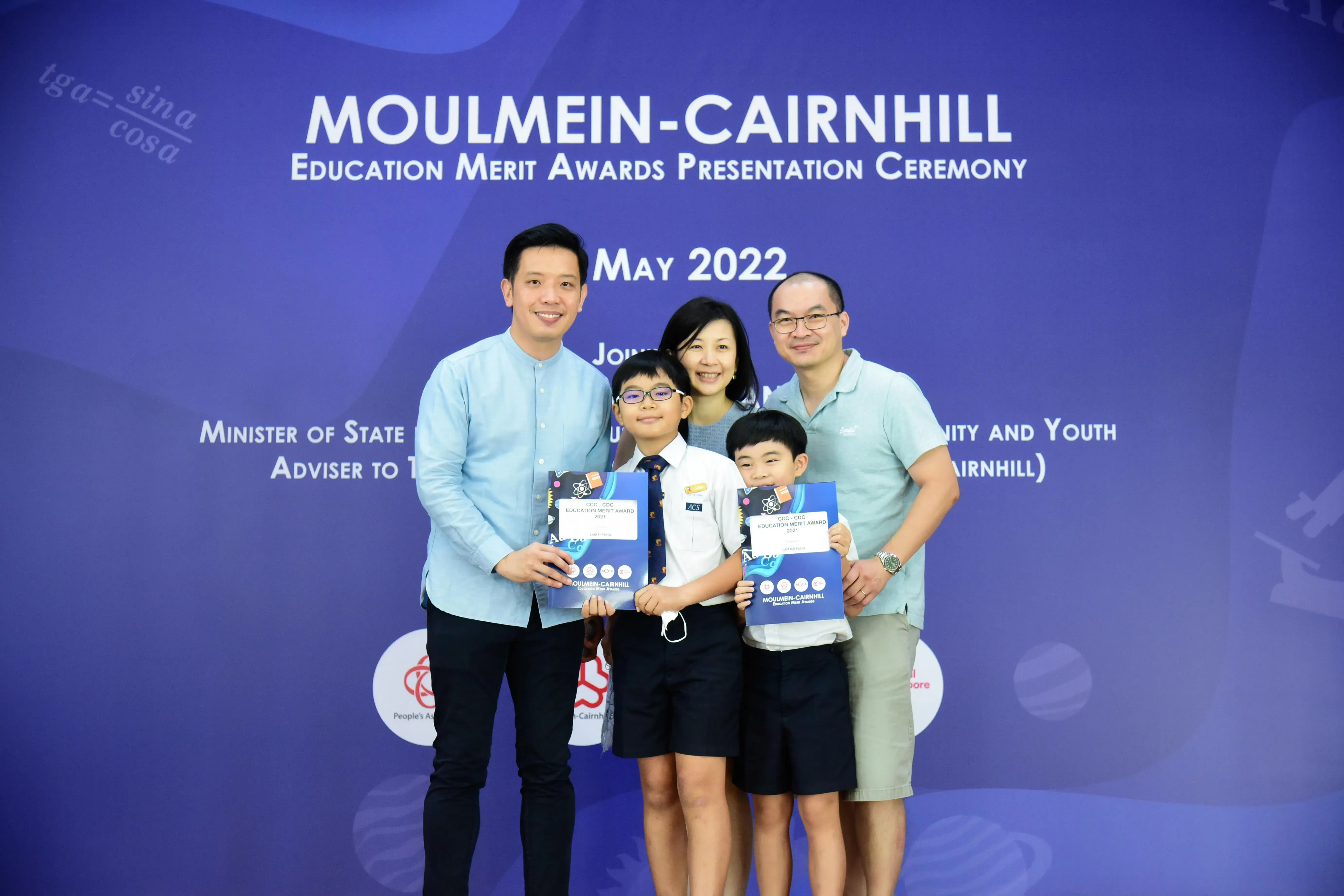 Five people pose with award folders at the Moulmein-Cairnhill Education Merit Awards Ceremony, May 2022.