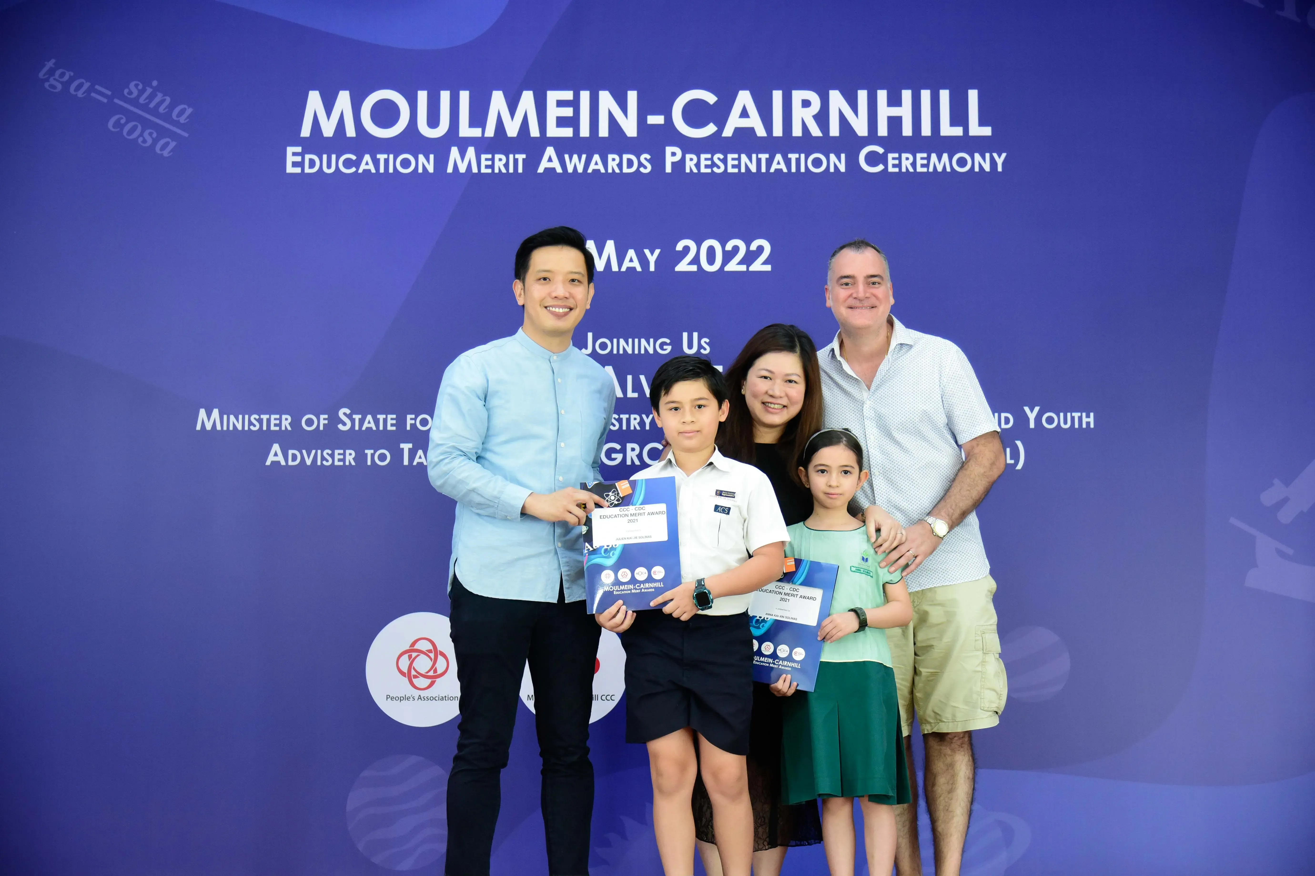 Five people pose with award certificates at the Moulmein-Cairnhill Education Merit Awards Ceremony, May 2022.