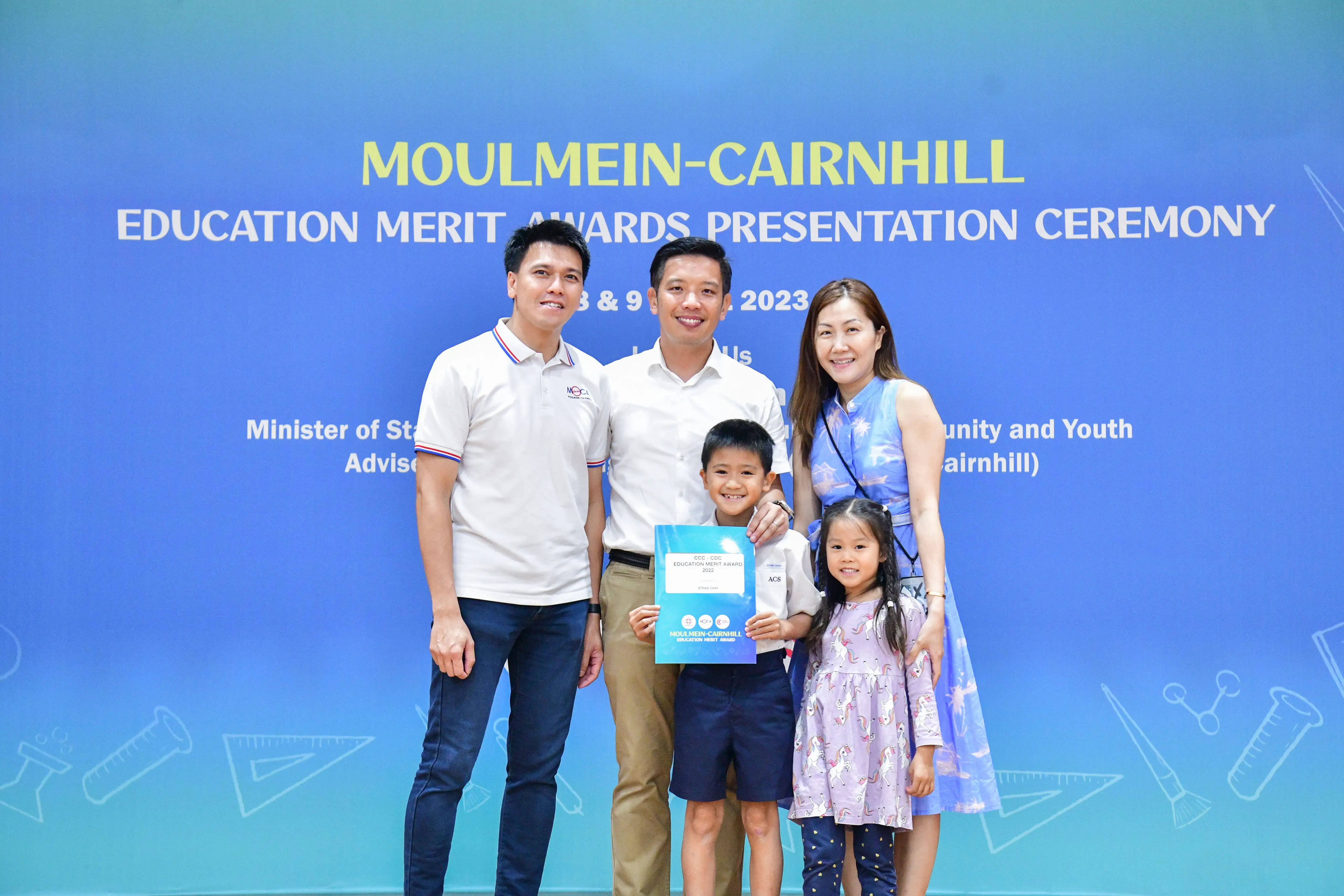 Two men, a woman, and two young children pose at the Moulmein-Cairnhill Education Merit Awards Ceremony 2023.