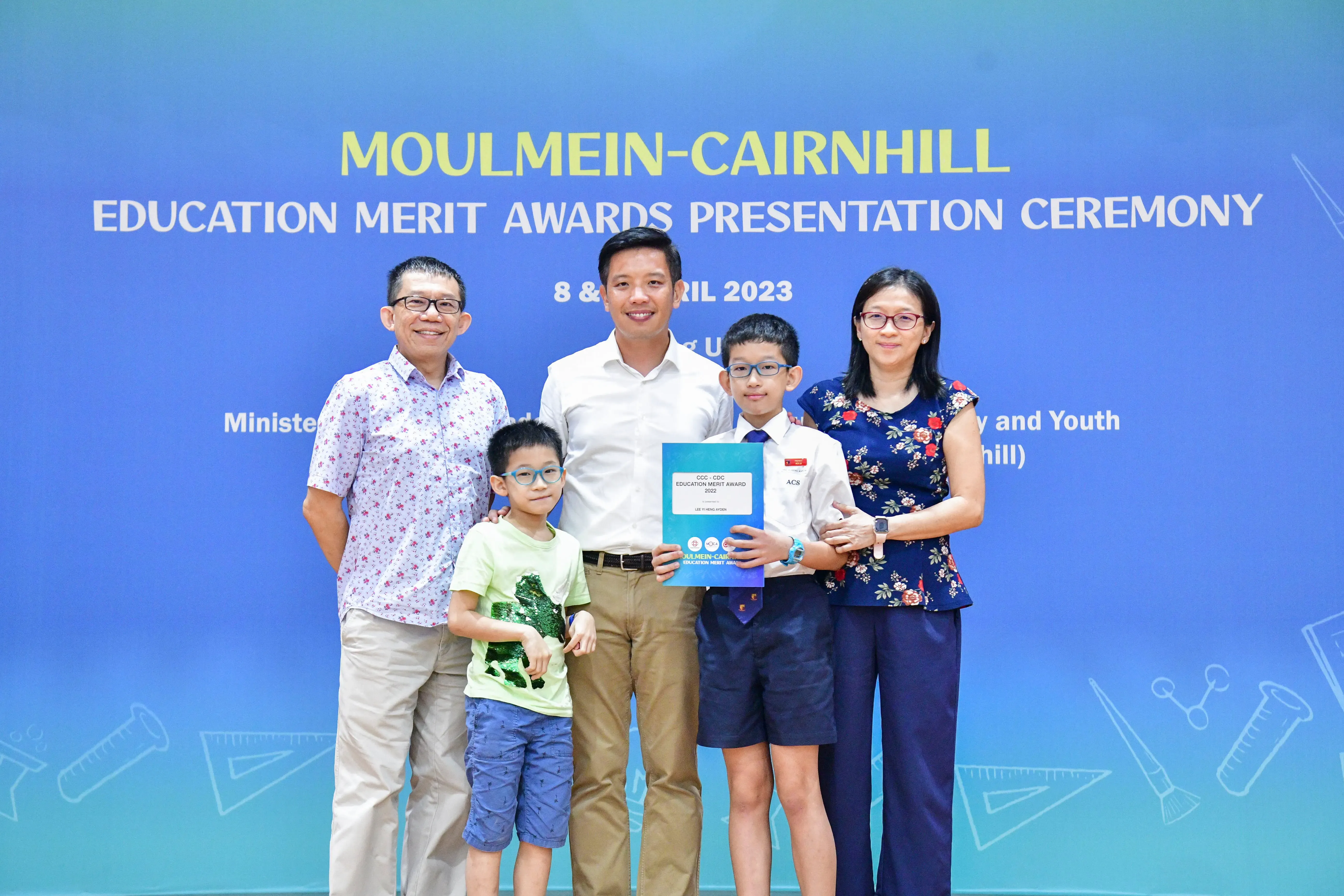 Five people pose at the Moulmein-Cairnhill Education Merit Awards Presentation Ceremony in April 2023.